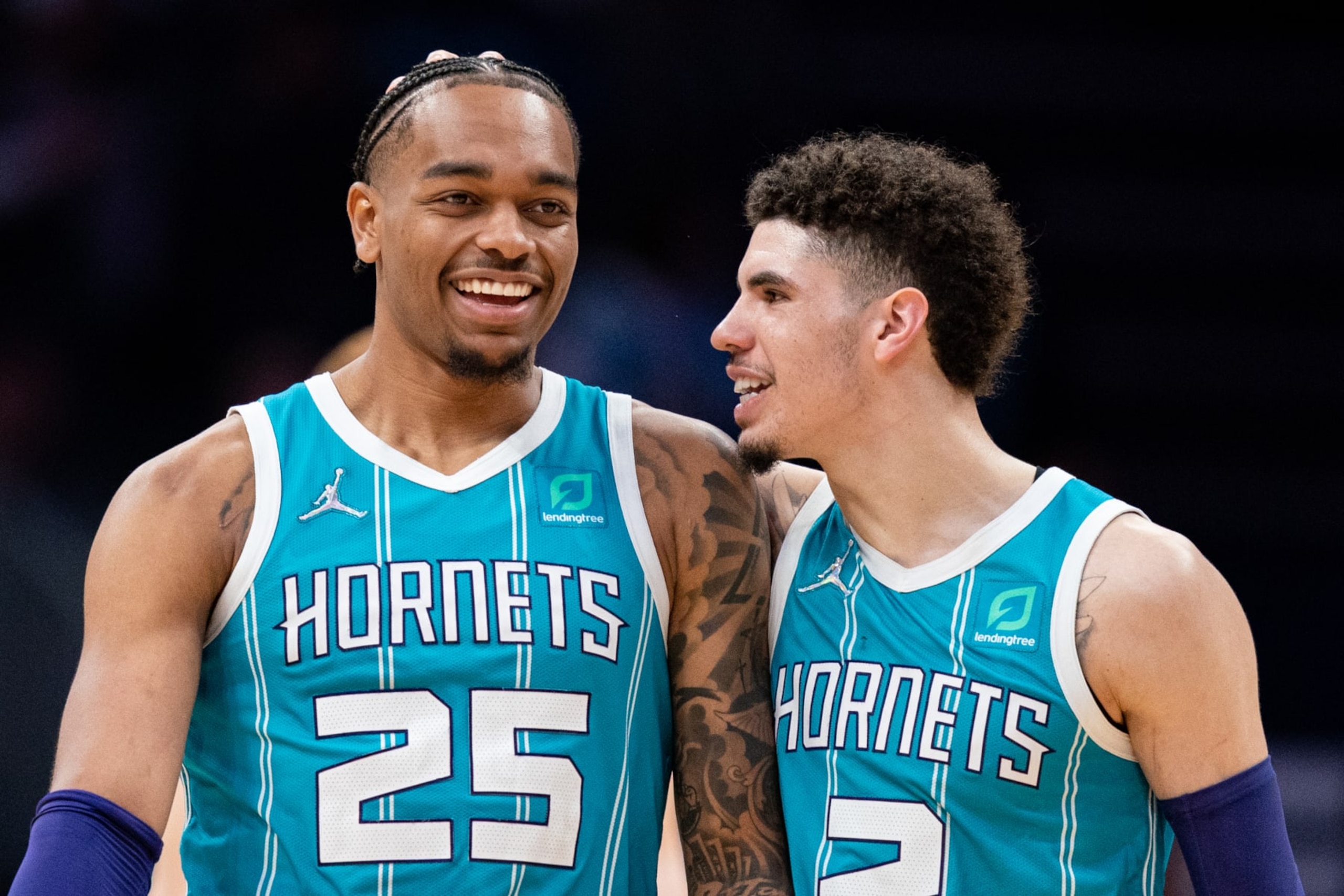 CHARLOTTE, NORTH CAROLINA - MARCH 16: LaMelo Ball #2 of the Charlotte Hornets (R) congratulates teammate P.J. Washington #25 in the fourth quarter during their game against the Atlanta Hawks at Spectrum Center on March 16, 2022 in Charlotte, North Carolina. NOTE TO USER: User expressly acknowledges and agrees that, by downloading and or using this photograph, User is consenting to the terms and conditions of the Getty Images License Agreement. (Photo by Jacob Kupferman/Getty Images)
