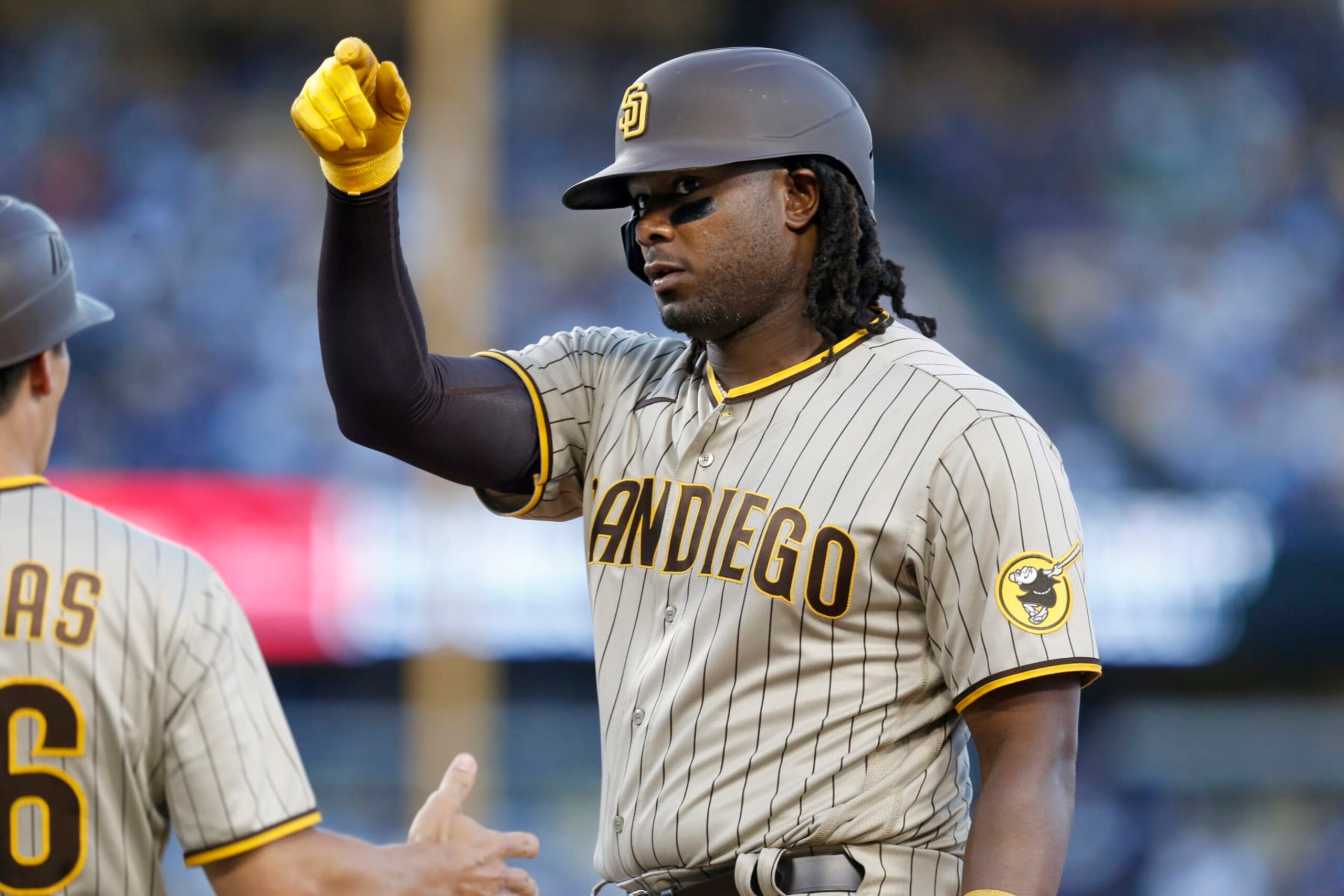 LOS ANGELES, CA - AUGUST 05: San Diego Padres first baseman Josh Bell (24) hits a single against Los Angeles Dodgers starting pitcher Tony Gonsolin (26) in the top of the  first inning in a game at Dodger Stadium on Friday, Aug. 5, 2022 in Los Angeles, CA. The Los Angeles Dodgers pay tribute to legendary broadcaster Vin Scully with a special pre-game ceremony prior to the game against the Padres. Vincent Edward Scully (November 29, 1927  August 2, 2022). (Gary Coronado / Los Angeles Times via Getty Images)