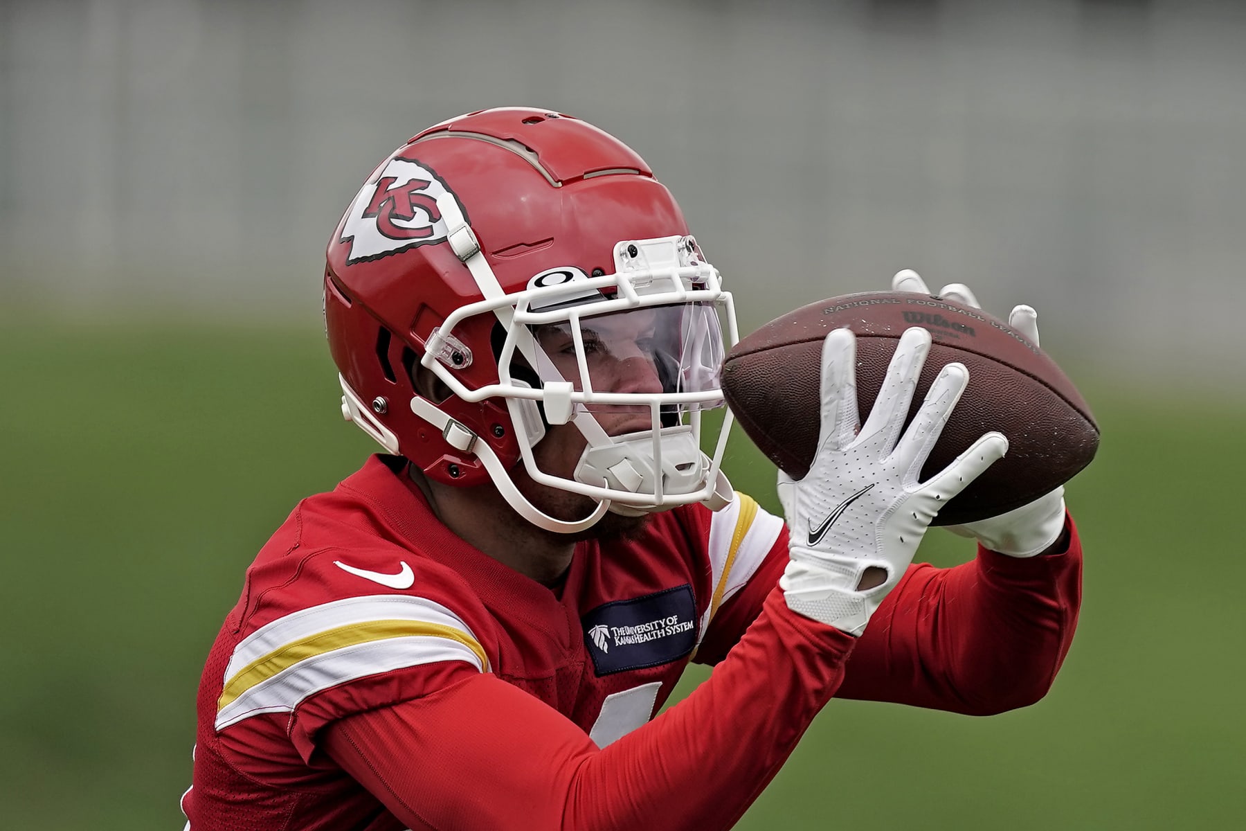 Kansas City Chiefs wide receiver Skyy Moore tries to catch a ball during the NFL football team's organized team activities Thursday, May 26, 2022, in Kansas City, Mo. (AP Photo/Charlie Riedel)