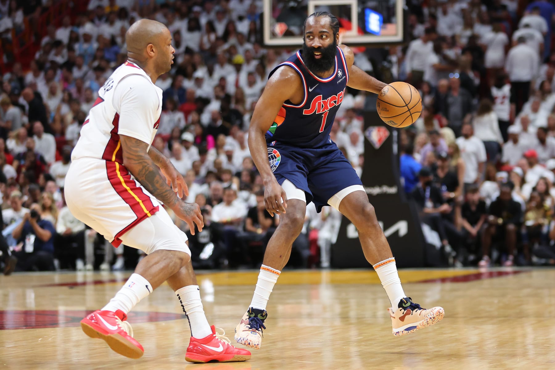 MIAMI, FLORIDA - MAY 10: James Harden #1 of the Philadelphia 76ers dribbles against P.J. Tucker #17 of the Miami Heat during the first half in Game Five of the Eastern Conference Semifinals at FTX Arena on May 10, 2022 in Miami, Florida. NOTE TO USER: User expressly acknowledges and agrees that, by downloading and or using this photograph, User is consenting to the terms and conditions of the Getty Images License Agreement.  (Photo by Michael Reaves/Getty Images)
