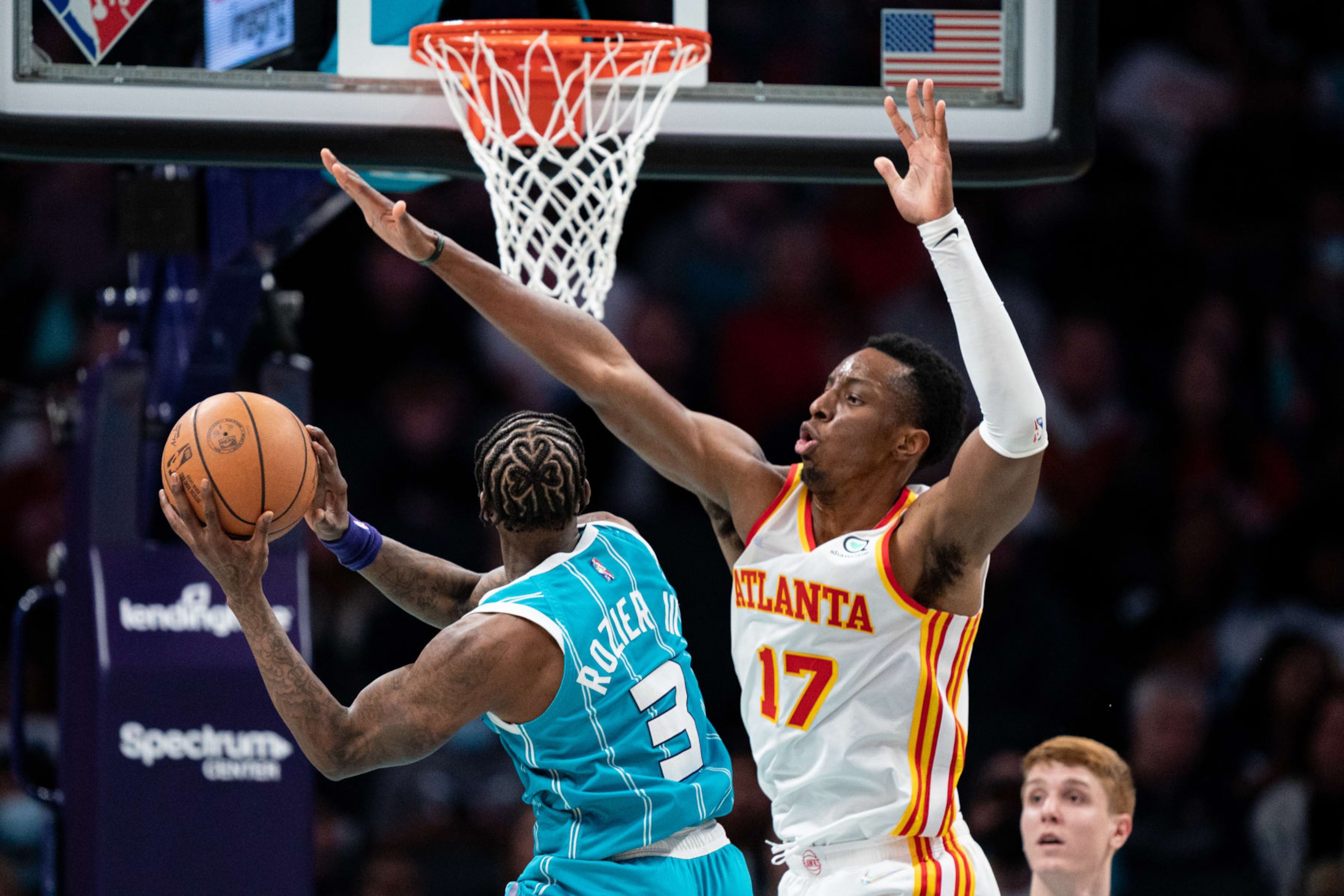 CHARLOTTE, NORTH CAROLINA - MARCH 16: Terry Rozier #3 of the Charlotte Hornets goes to the basket while guarded by Onyeka Okongwu #17 of the Atlanta Hawks in the fourth quarter during their game at Spectrum Center on March 16, 2022 in Charlotte, North Carolina. NOTE TO USER: User expressly acknowledges and agrees that, by downloading and or using this photograph, User is consenting to the terms and conditions of the Getty Images License Agreement. (Photo by Jacob Kupferman/Getty Images)