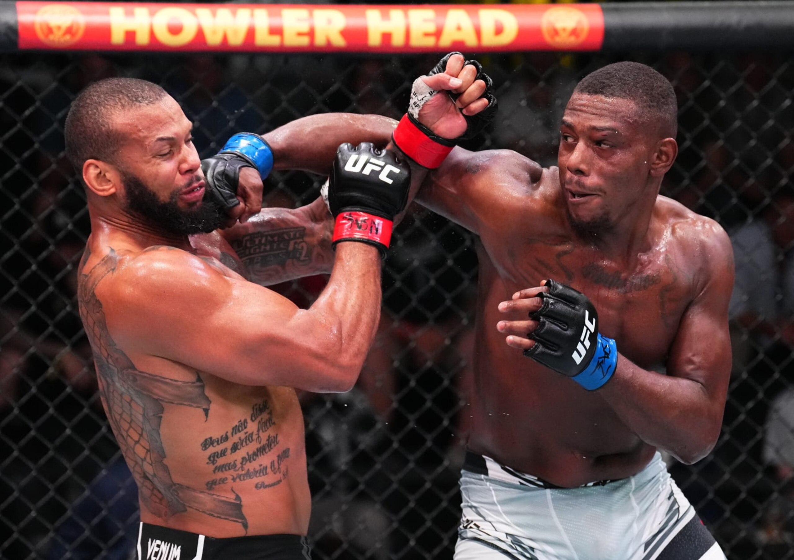 LAS VEGAS, NEVADA - AUGUST 06: (R-L) Jamahal Hill punches Thiago Santos of Brazil in a light heavyweight fight during the UFC Fight Night event at UFC APEX on August 06, 2022 in Las Vegas, Nevada. (Photo by Chris Unger/Zuffa LLC)