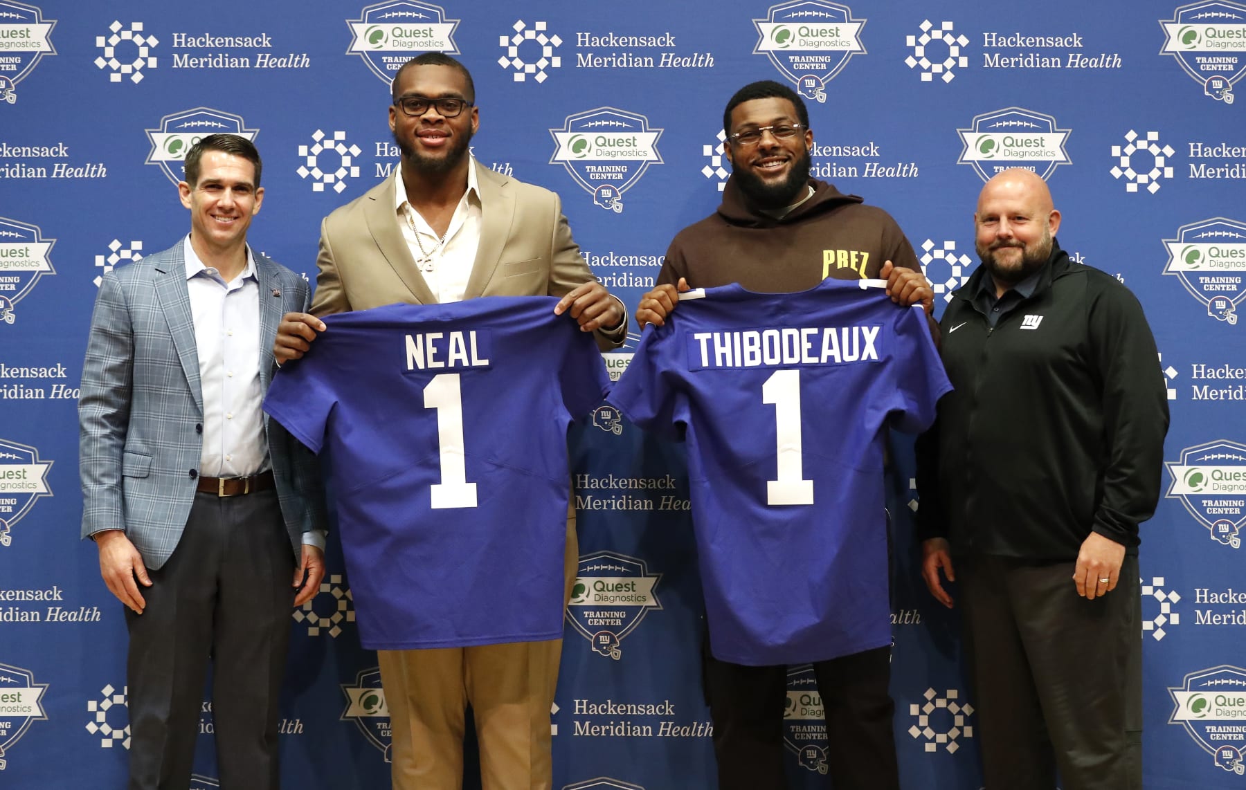 New York Giants general manager Joe Schoen, left, and head coach Brian Daboll, right, introduce NFL football draft picks Evan Neal and Kayvon Thibodeaux, during a press conference in East Rutherford, N.J. on Saturday, April 30, 2022. (AP Photo/Noah K. Murray)