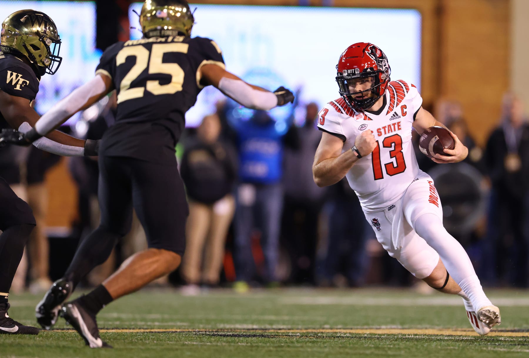 WINSTON-SALEM, NORTH CAROLINA - NOVEMBER 13: Devin Leary #13 of the North Carolina State Wolfpack runs against the Wake Forest Demon Deacons during their game at Truist Field on November 13, 2021 in Winston-Salem, North Carolina. Wake Forest won 45-42. (Photo by Grant Halverson/Getty Images)