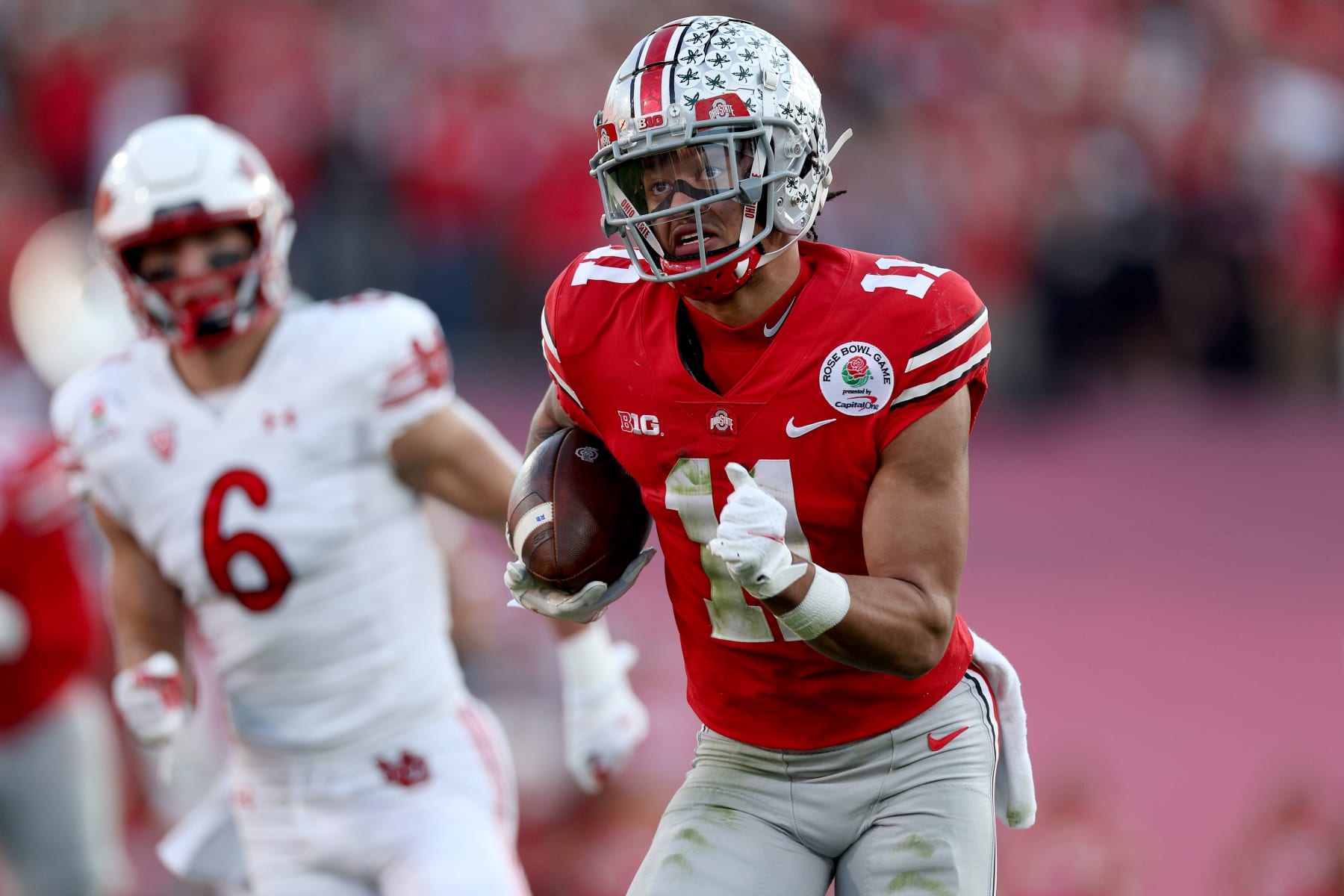 PASADENA, CALIFORNIA - JANUARY 01: Jaxon Smith-Njigba #11 of the Ohio State Buckeyes carries the ball after a reception during the first half against the Utah Utes in the Rose Bowl Game at Rose Bowl Stadium on January 01, 2022 in Pasadena, California. (Photo by Harry How/Getty Images)