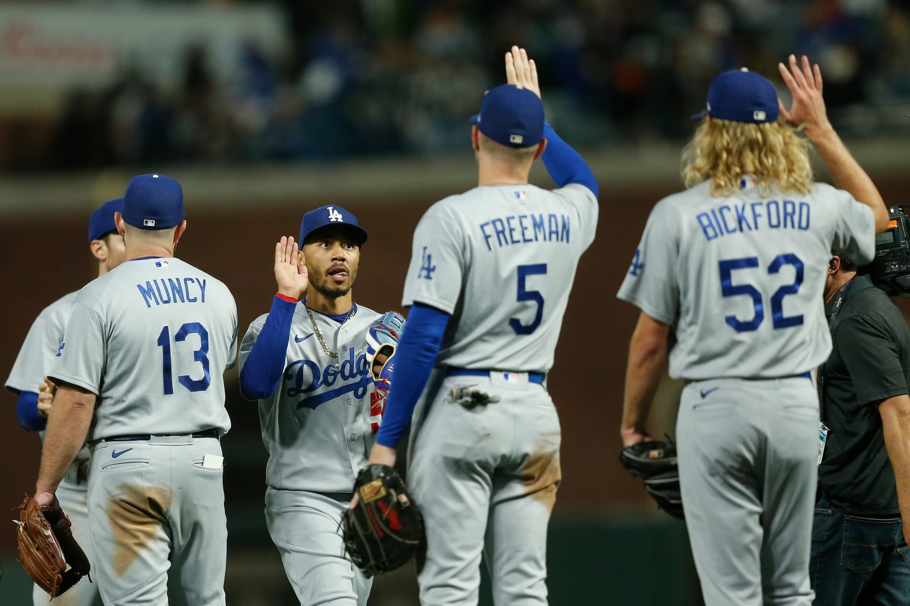 SAN FRANCISCO, CALIFORNIA - AUGUST 01: Mookie Betts #50 of the Los Angeles Dodgers celebrates with teammates Max Muncy #13, Freddie Freeman #5 and Phil Bickford #52 after a win against the San Francisco Giants at Oracle Park on August 01, 2022 in San Francisco, California. (Photo by Lachlan Cunningham/Getty Images)