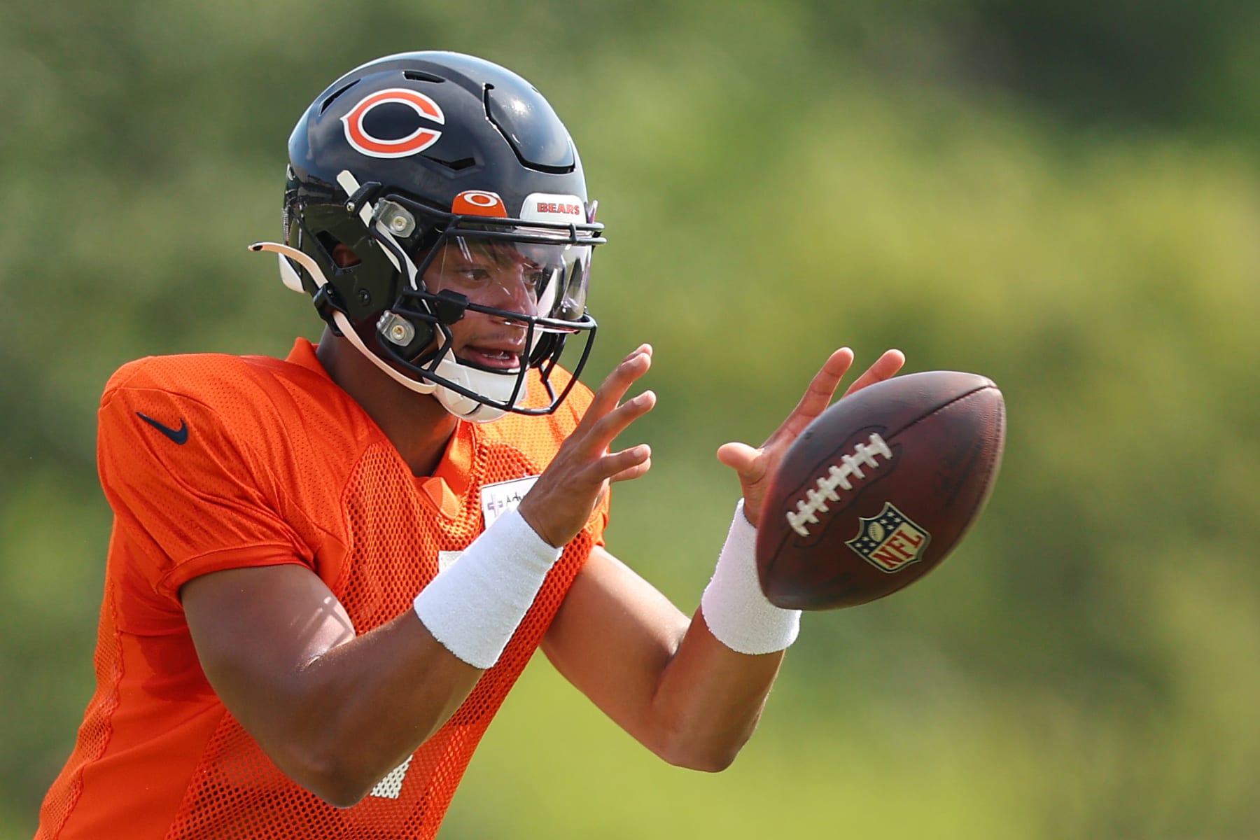 LAKE FOREST, ILLINOIS - AUGUST 02: Justin Fields #1 of the Chicago Bears takes part in a drill during training camp at the PNC Center at Halas Hall on August 02, 2022 in Lake Forest, Illinois. (Photo by Michael Reaves/Getty Images)