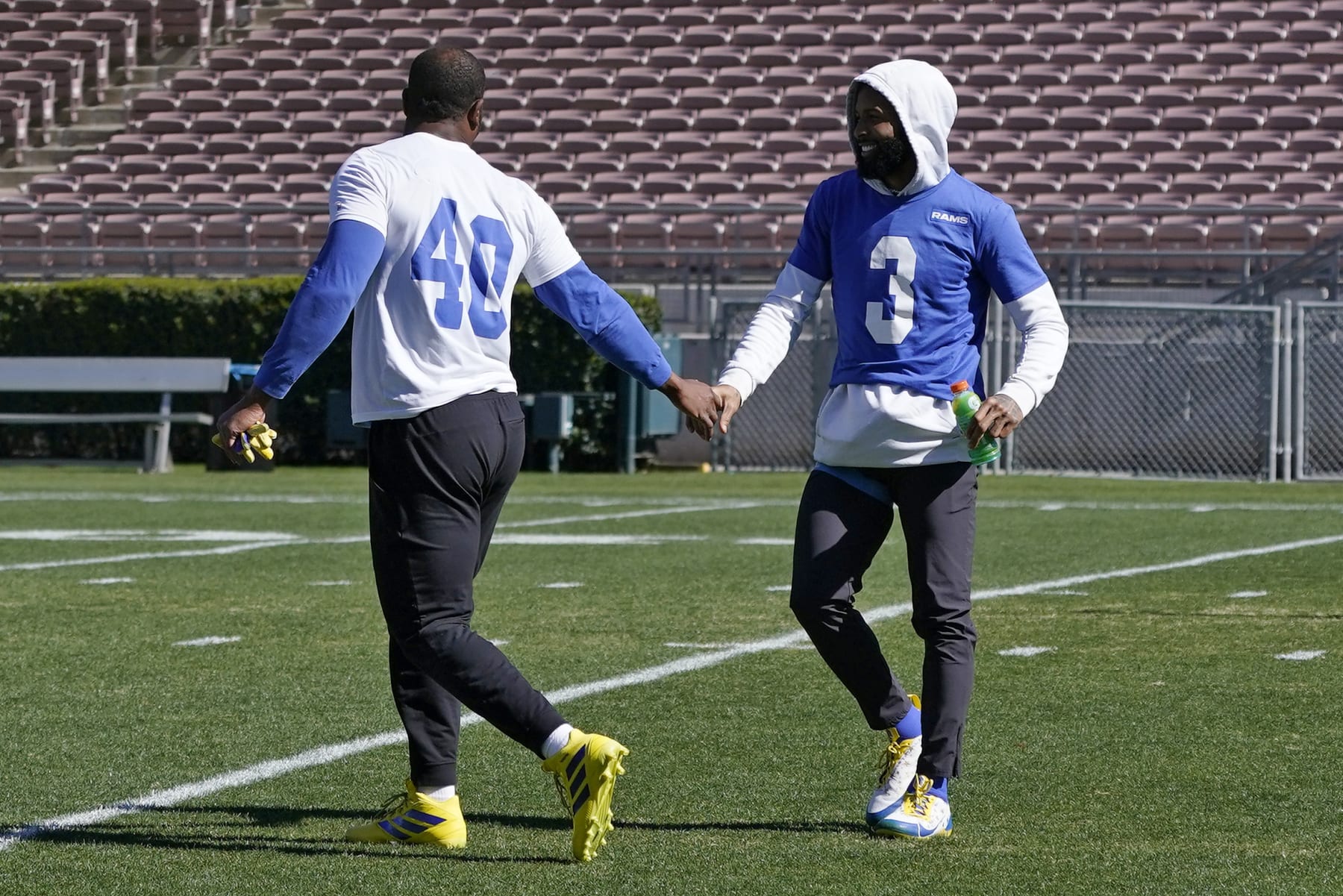 Los Angeles Rams outside linebacker Von Miller, left, and wide receiver Odell Beckham Jr. greet each other during practice for an NFL Super Bowl football game Thursday, Feb. 10, 2022, in Pasadena, Calif. The Rams are scheduled to play the Cincinnati Bengals in the Super Bowl on Sunday. (AP Photo/Mark J. Terrill)