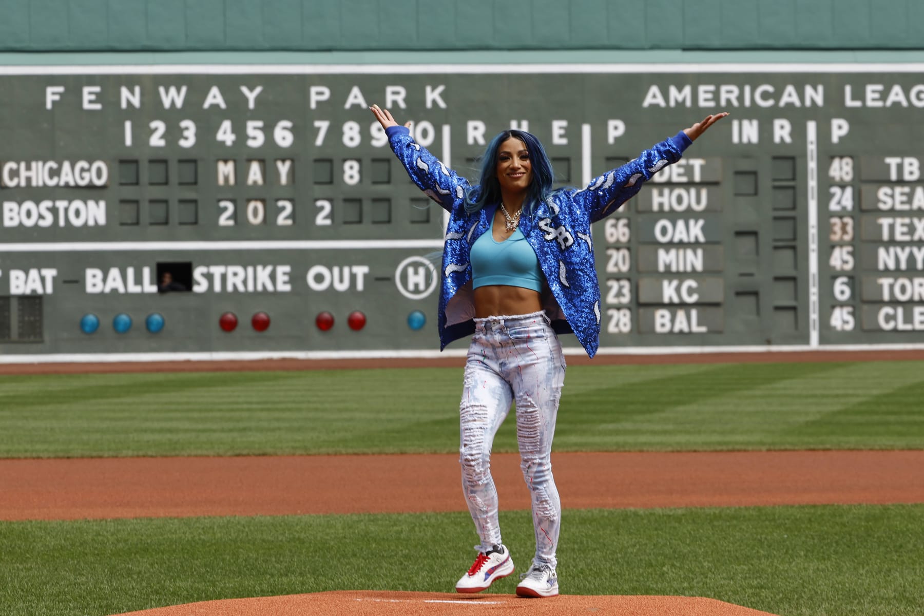 BOSTON, MA - MAY 8: Six time WWE Womens Champion Sasha Banks holds up her arms after throwing out the first pitch before the game between the Boston Red Sox and the Chicago White Sox at Fenway Park on May 8, 2022 in Boston, Massachusetts. (Photo By Winslow Townson/Getty Images)
