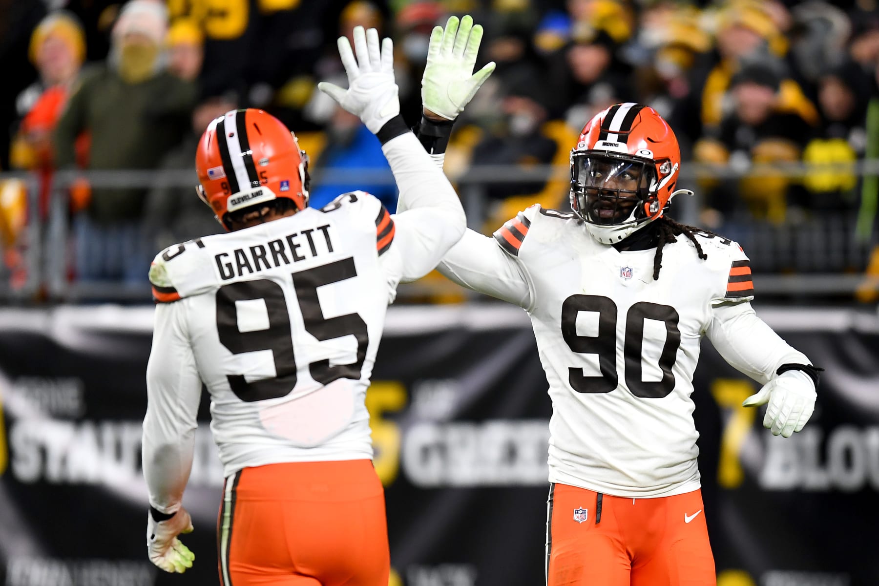 PITTSBURGH, PENNSYLVANIA - JANUARY 03: Myles Garrett #95 of the Cleveland Browns high-fives teammate Jadeveon Clowney #90 in the third quarter against the Pittsburgh Steelers at Heinz Field on January 03, 2022 in Pittsburgh, Pennsylvania. (Photo by Joe Sargent/Getty Images)