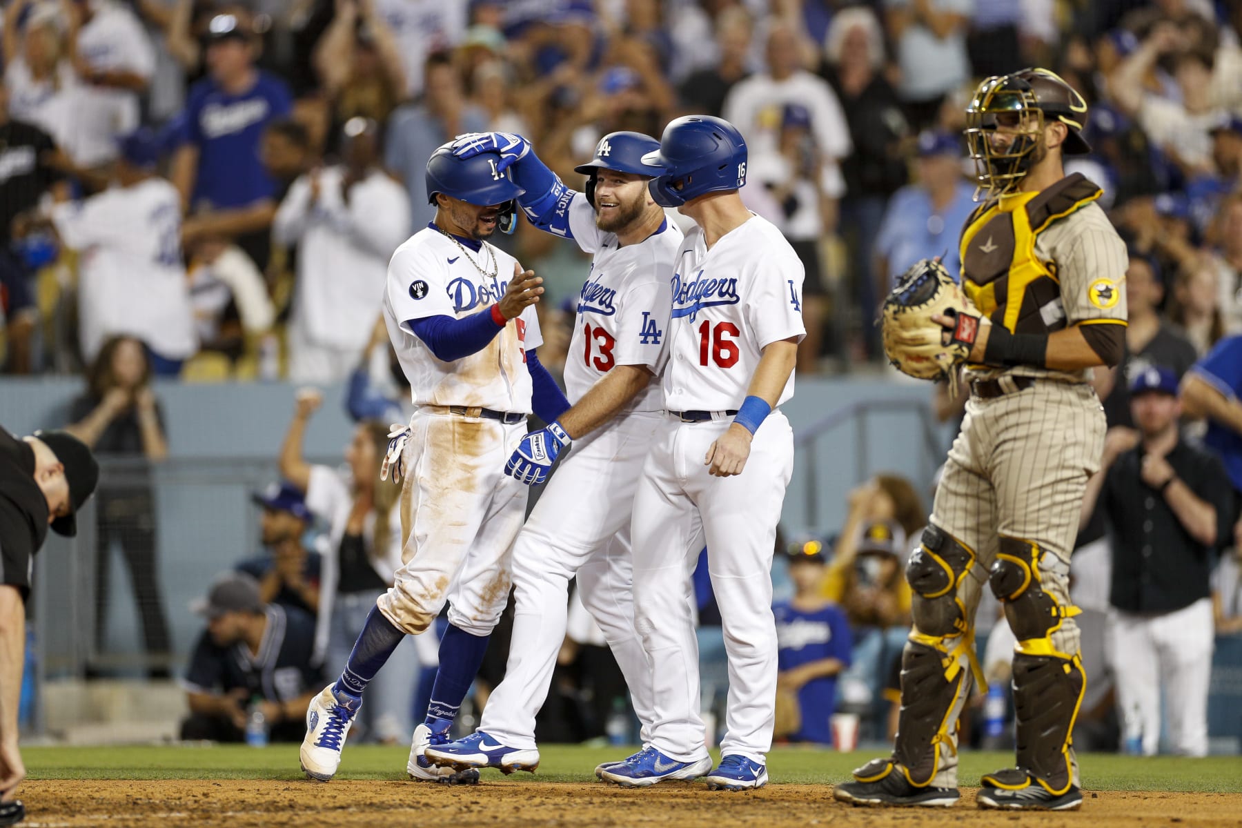LOS ANGELES, CA - AUGUST 06: Los Angeles Dodgers right fielder Mookie Betts (50) and catcher Will Smith (16) score on a home run hit by third baseman Max Muncy (13) during a regular season game between the San Diego Padres and Los Angeles Dodgers on August 06, 2022, at Dodger Stadium in Los Angeles, CA. (Photo by Brandon Sloter/Icon Sportswire via Getty Images)