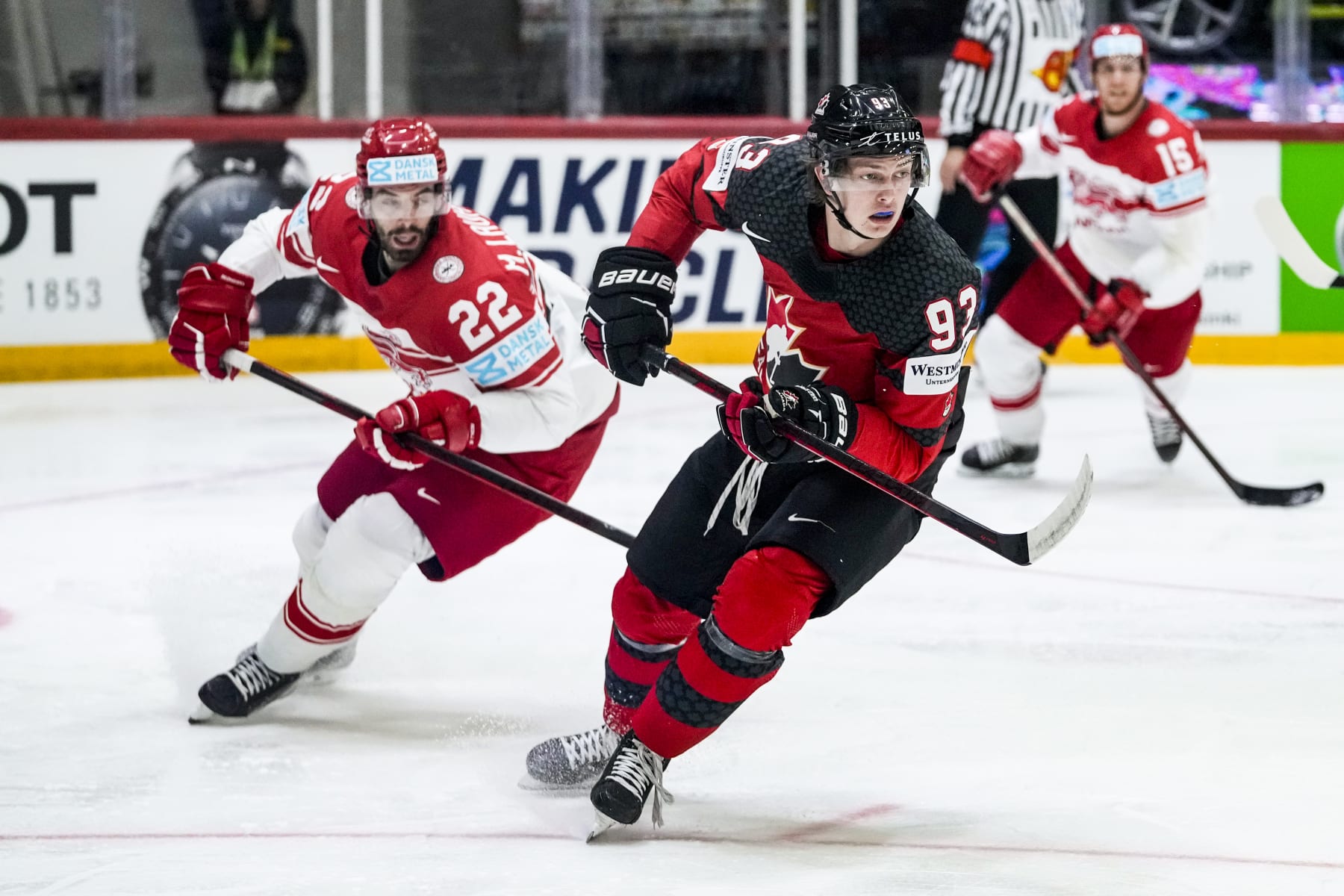 HELSINKI, FINLAND - MAY 23: Markus Lauridsen of Denmark (L) against Kent Johnson of Canada (R) during the 2022 IIHF Ice Hockey World Championship match between Canada and Denmark at Helsinki Ice Hall on May 23, 2022 in Helsinki, Finland. (Photo by Jari Pestelacci/Eurasia Sport Images/Getty Images)
