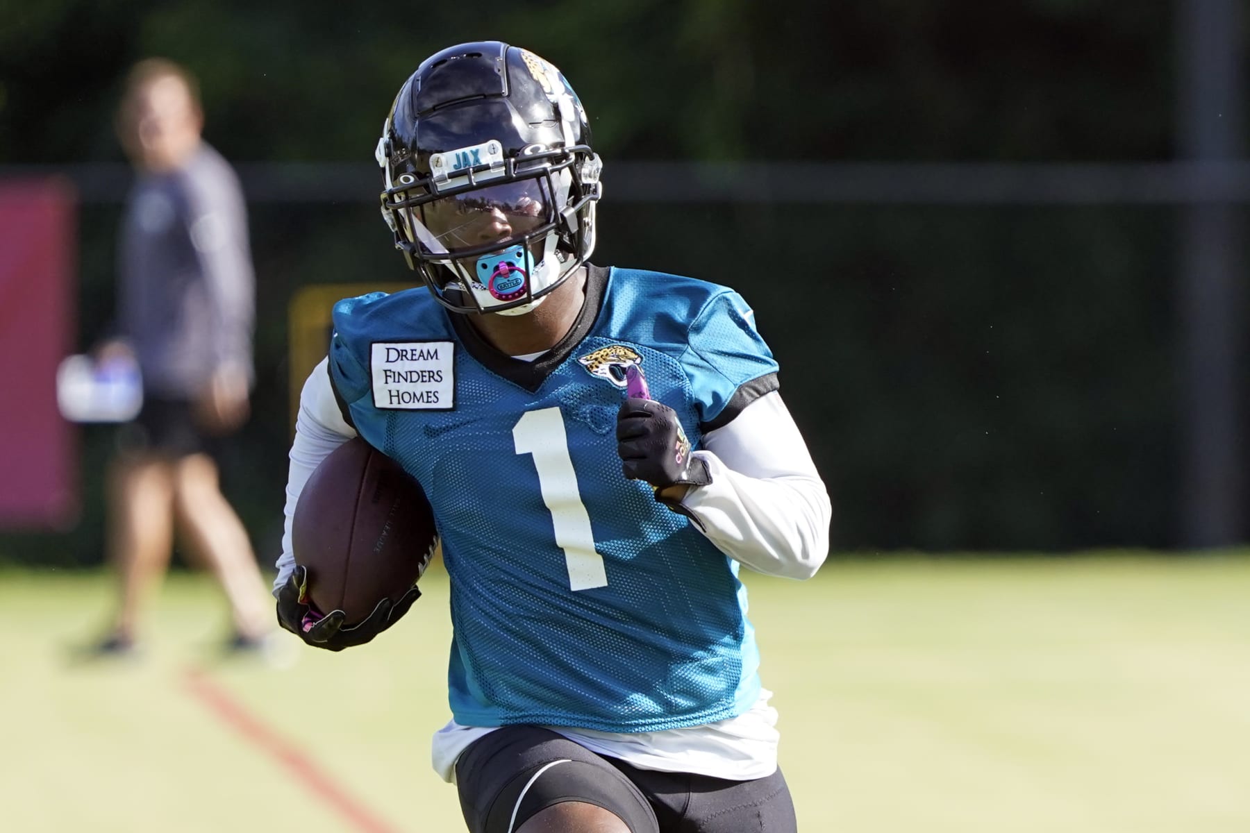 Jacksonville Jaguars running back Travis Etienne (1) runs after a reception during an NFL football practice, Tuesday, July 26, 2022, in Jacksonville, Fla. (AP Photo/John Raoux)