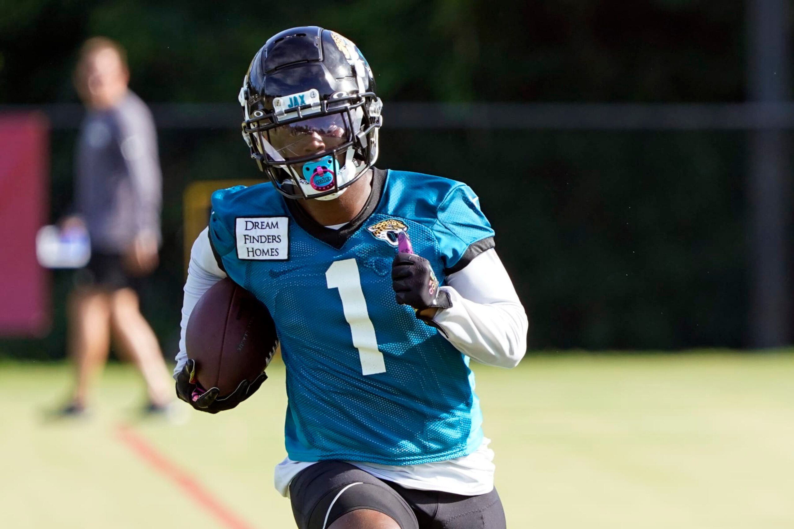 Jacksonville Jaguars running back Travis Etienne (1) runs after a reception during an NFL football practice, Tuesday, July 26, 2022, in Jacksonville, Fla. (AP Photo/John Raoux)