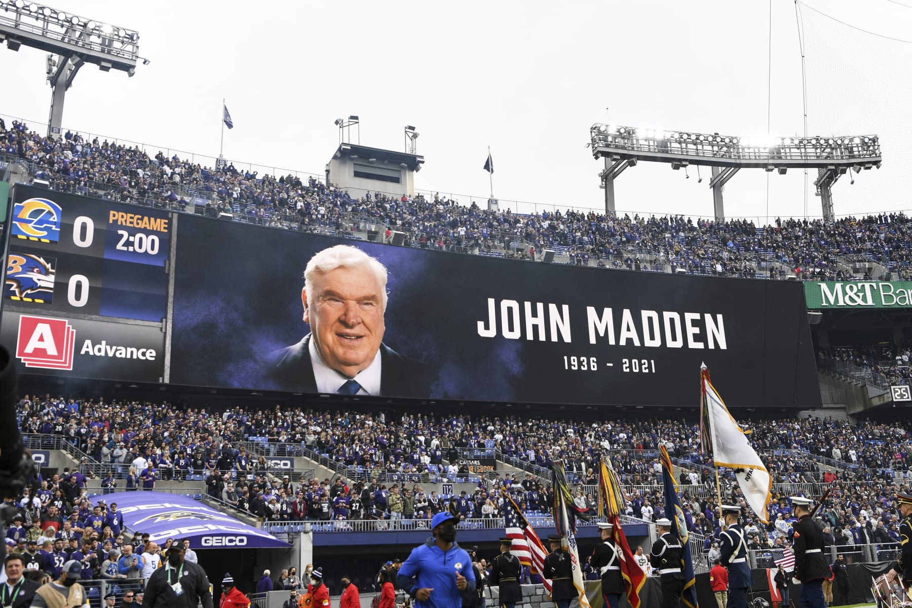 A moment of silence is given to John Madden who recently passed away before an NFL football game between the Baltimore Ravens and the Los Angeles Rams, Sunday, Jan. 2, 2022, in Baltimore. (AP Photo/Terrance Williams)