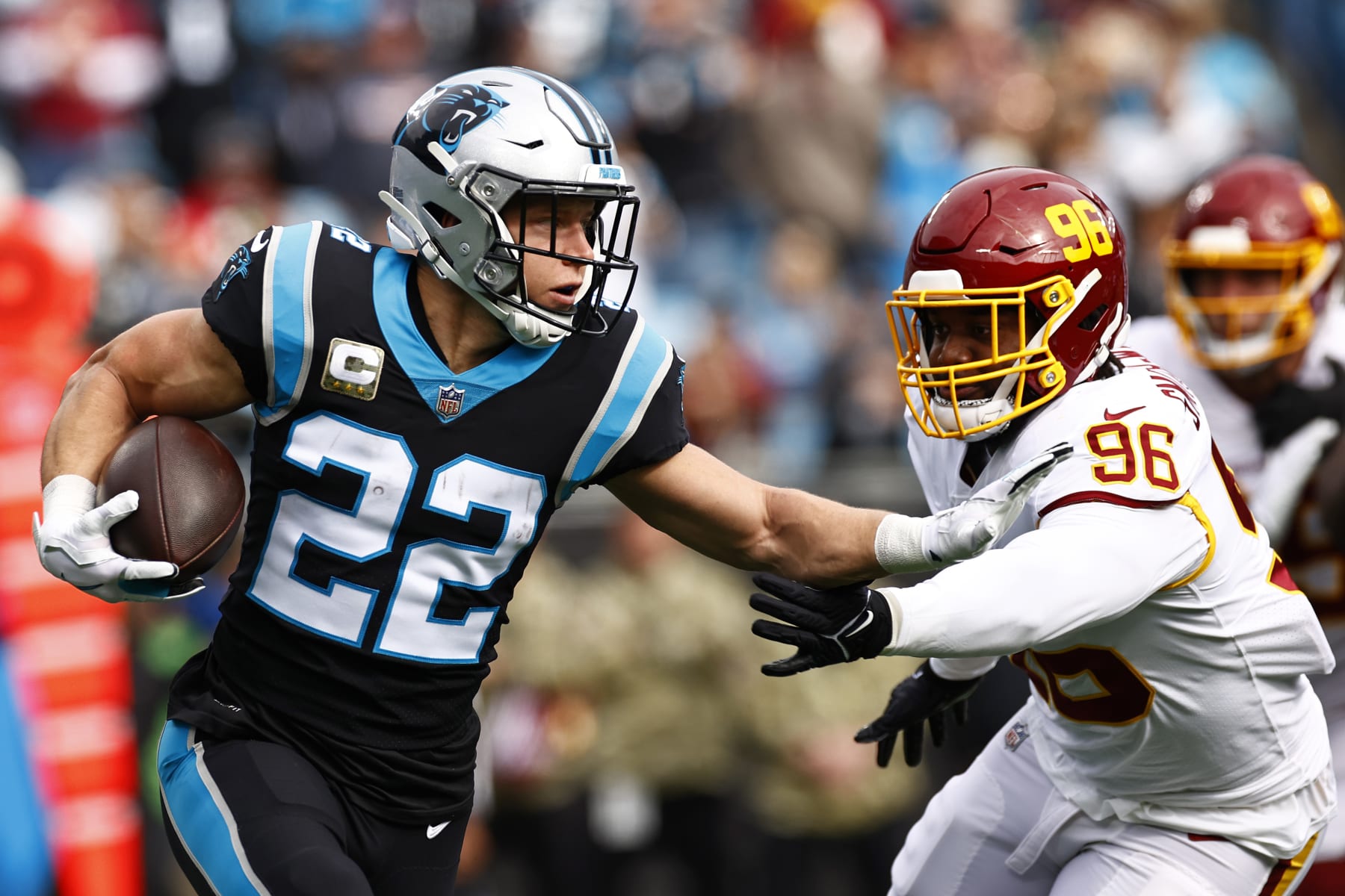 CHARLOTTE, NORTH CAROLINA - NOVEMBER 21: Christian McCaffrey #22 of the Carolina Panthers carries the ball against the defense of the Washington Football Team in the first quarter of the game at Bank of America Stadium on November 21, 2021 in Charlotte, North Carolina. (Photo by Jared C. Tilton/Getty Images)