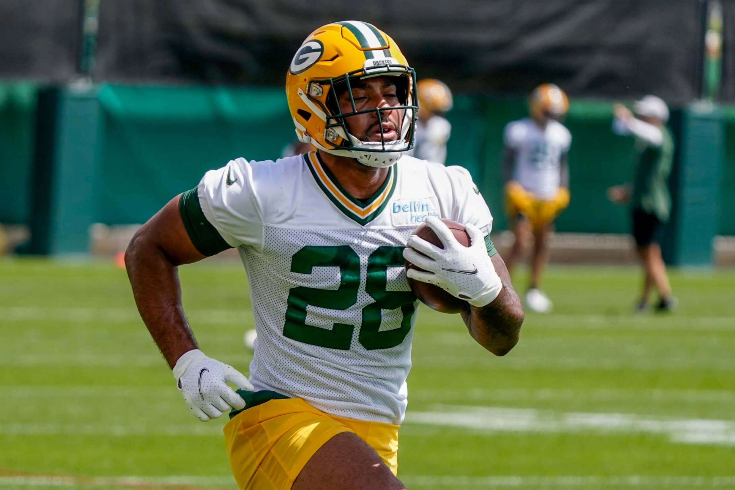 Green Bay Packers' AJ Dillon runs a drill at the NFL football team's practice field training camp Tuesday, May 24, 2022, in Green Bay, Wis. (AP Photo/Morry Gash)