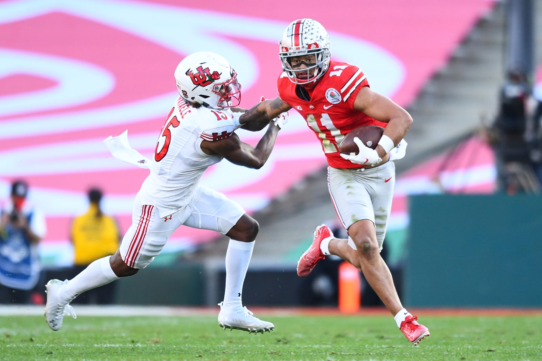 PASADENA, CA - JANUARY 01: Ohio State Buckeyes wide receiver Jaxon Smith-Njigba (11) runs past the tackle of Utah Utes cornerback Malone Mataele (15) during the Rose Bowl game between the Ohio State Buckeyes and the Utah Utes on January 1, 2022 at the Rose Bowl in Pasadena, CA. (Photo by Brian Rothmuller/Icon Sportswire via Getty Images)