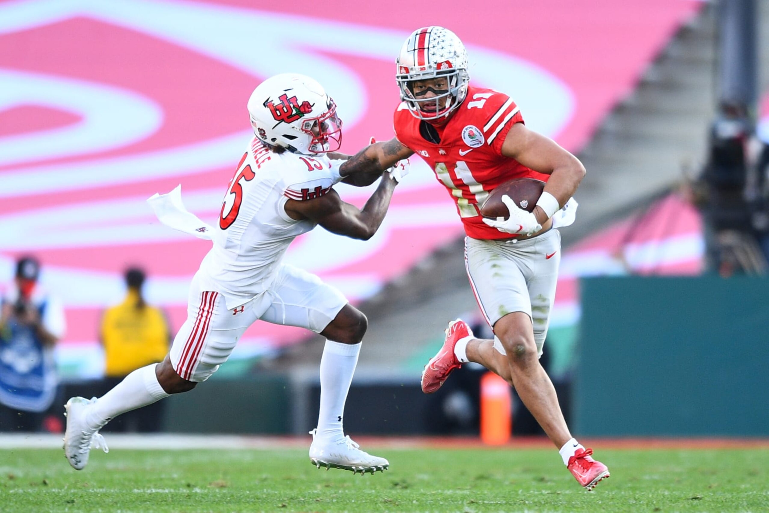 PASADENA, CA - JANUARY 01: Ohio State Buckeyes wide receiver Jaxon Smith-Njigba (11) runs past the tackle of Utah Utes cornerback Malone Mataele (15) during the Rose Bowl game between the Ohio State Buckeyes and the Utah Utes on January 1, 2022 at the Rose Bowl in Pasadena, CA. (Photo by Brian Rothmuller/Icon Sportswire via Getty Images)