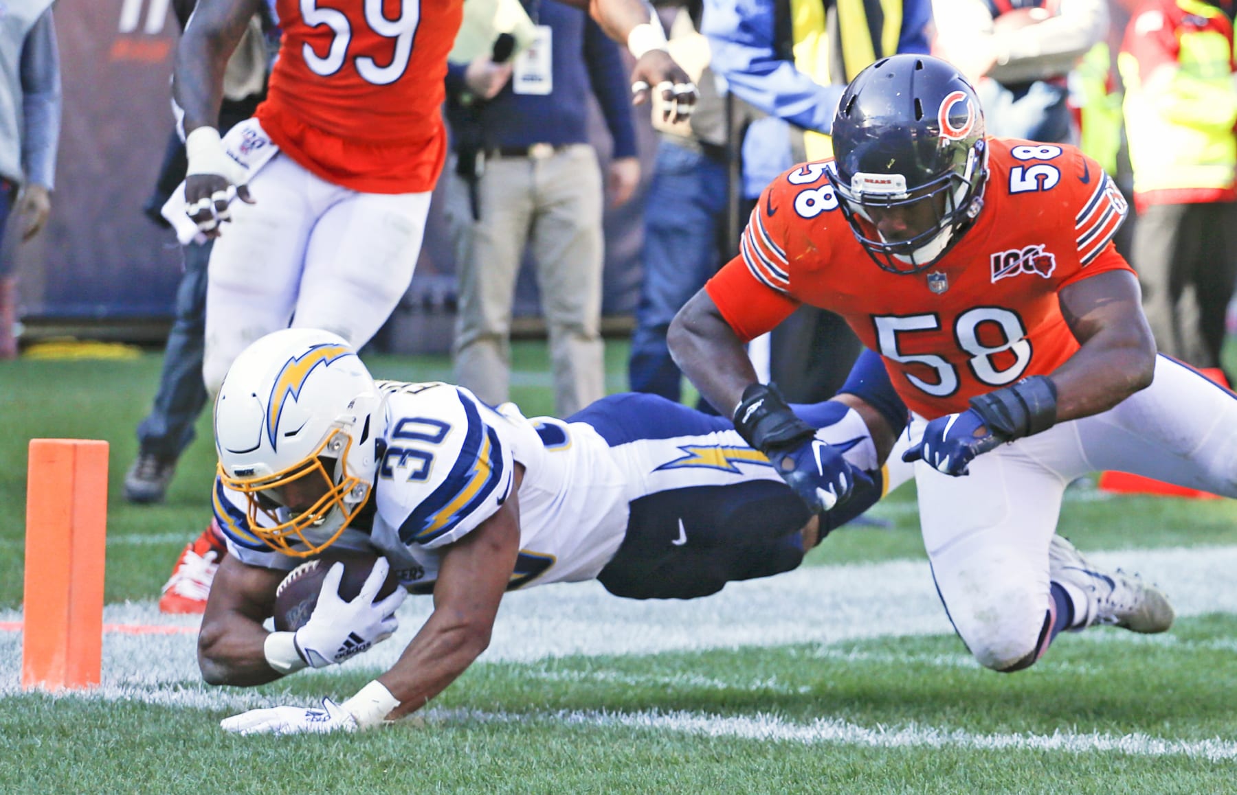 CHICAGO, ILLINOIS - OCTOBER 27: Austin Ekeler #30 of the Los Angeles Chargers scores a touchdown in front of Roquan Smith #58 of the Chicago Bears during the second half at Soldier Field on October 27, 2019 in Chicago, Illinois. (Photo by Nuccio DiNuzzo/Getty Images)