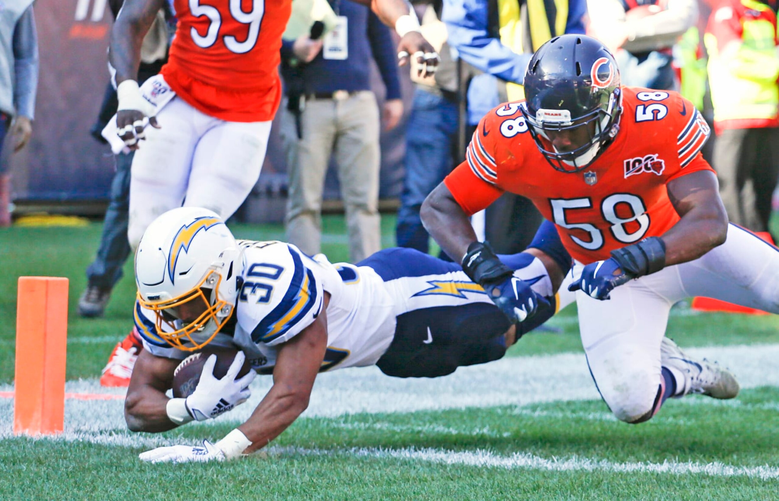 CHICAGO, ILLINOIS - OCTOBER 27: Austin Ekeler #30 of the Los Angeles Chargers scores a touchdown in front of Roquan Smith #58 of the Chicago Bears during the second half at Soldier Field on October 27, 2019 in Chicago, Illinois. (Photo by Nuccio DiNuzzo/Getty Images)
