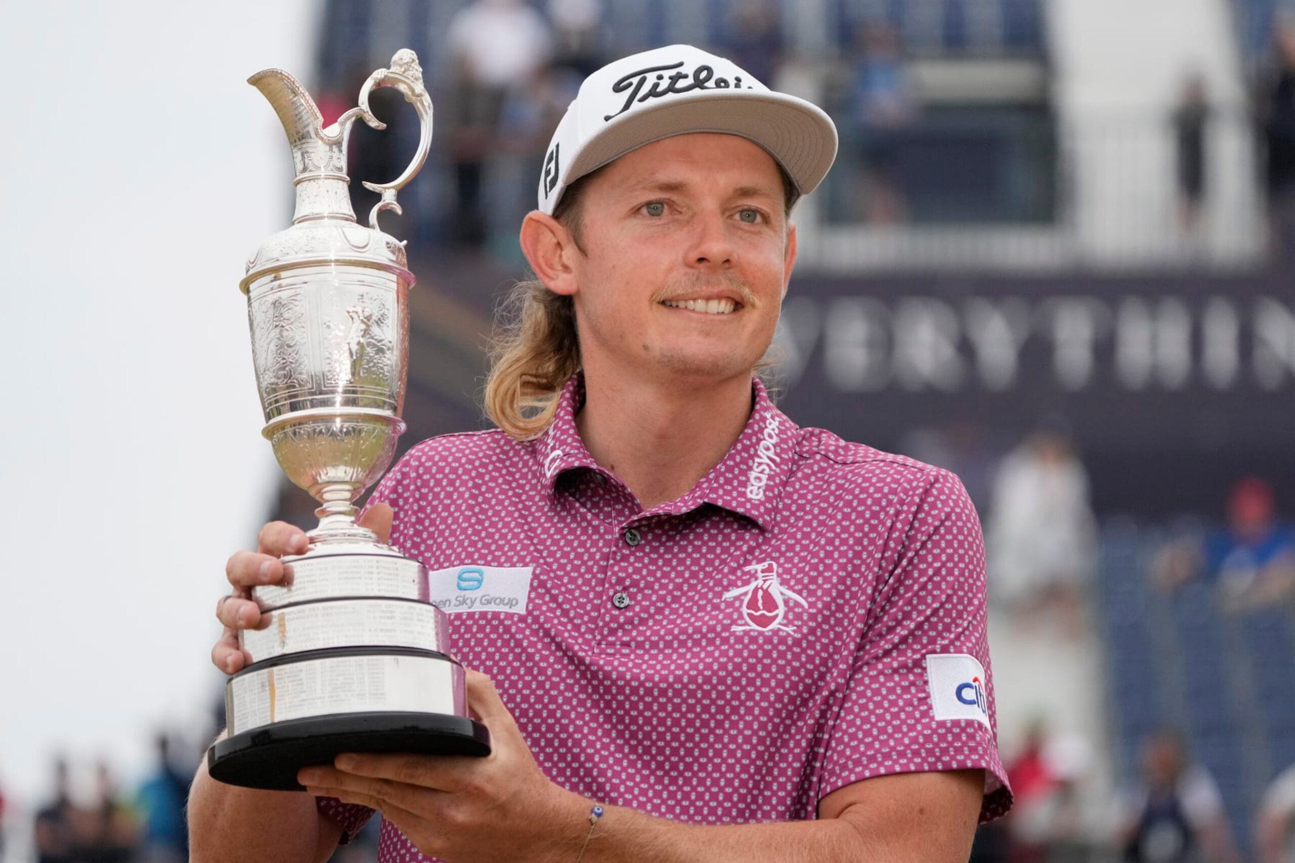Cameron Smith, of Australia, holds the claret jug trophy as he poses for photographers on the 18th green after winning the British Open golf Championship on the Old Course at St. Andrews, Scotland, Sunday July 17, 2022. (AP Photo/Gerald Herbert)