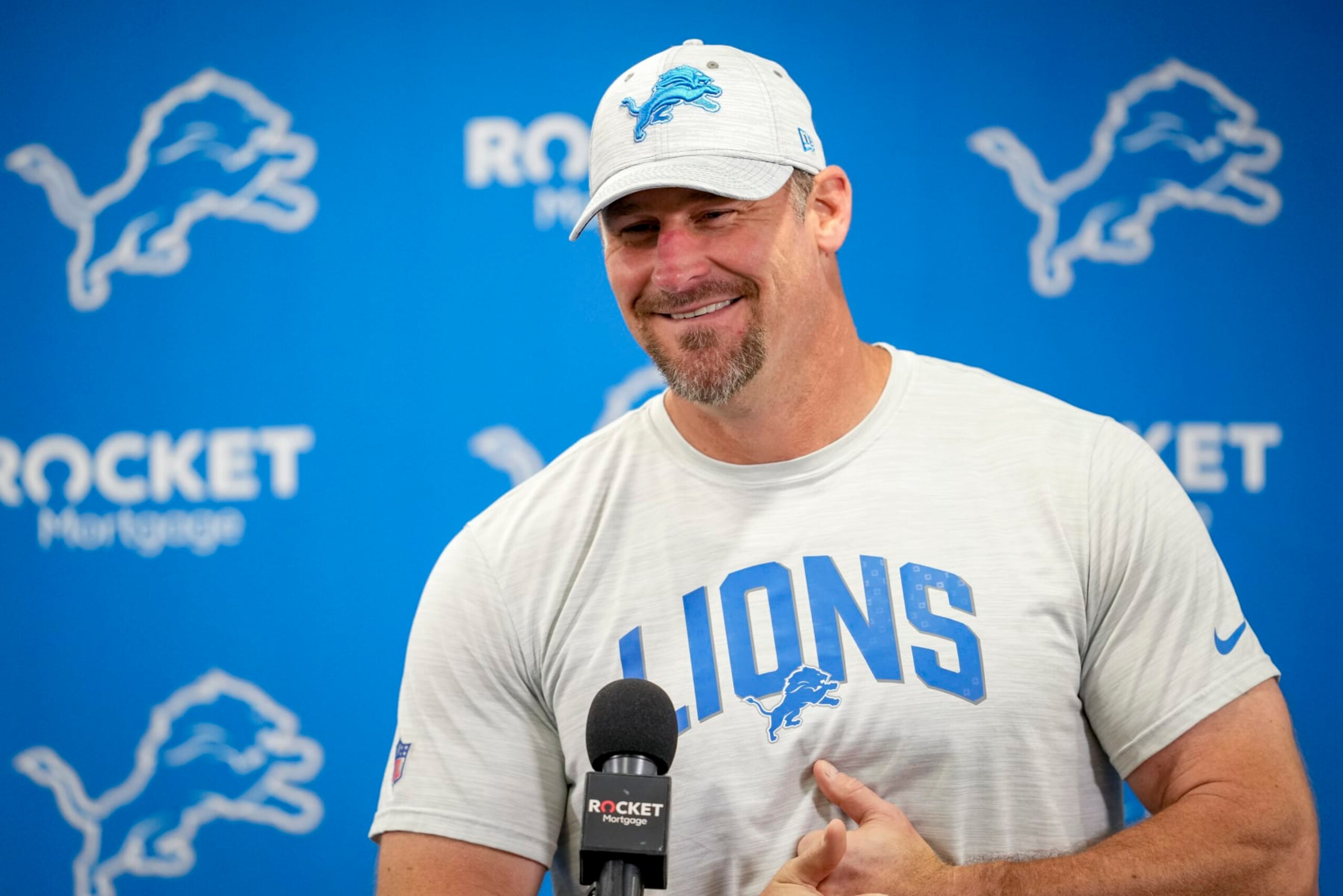 ALLEN PARK, MICHIGAN - JULY 29: Head coach Dan Campbell of the Detroit Lions smile while answering questions from reporters during the Detroit Lions Training Camp at the Lions Headquarters and Training Facility on July 29, 2022 in Allen Park, Michigan. (Photo by Nic Antaya/Getty Images)