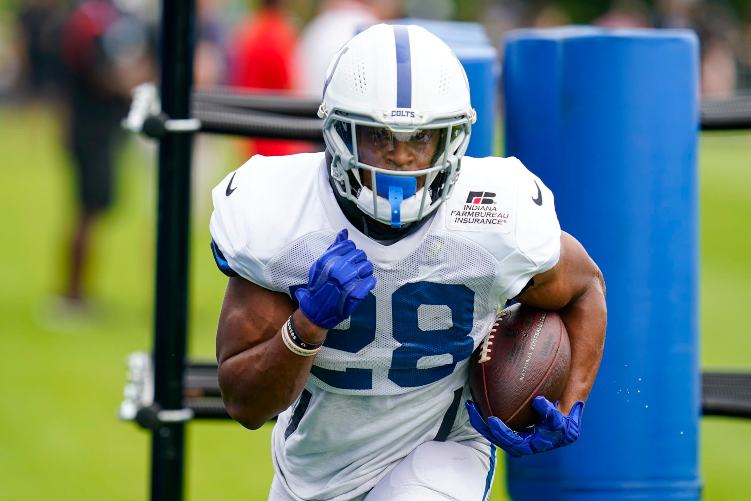 Indianapolis Colts running back Jonathan Taylor (28) runs a drill during practice at the NFL team's football training camp in Westfield, Ind., Tuesday, Aug. 2, 2022. (AP Photo/Michael Conroy)
