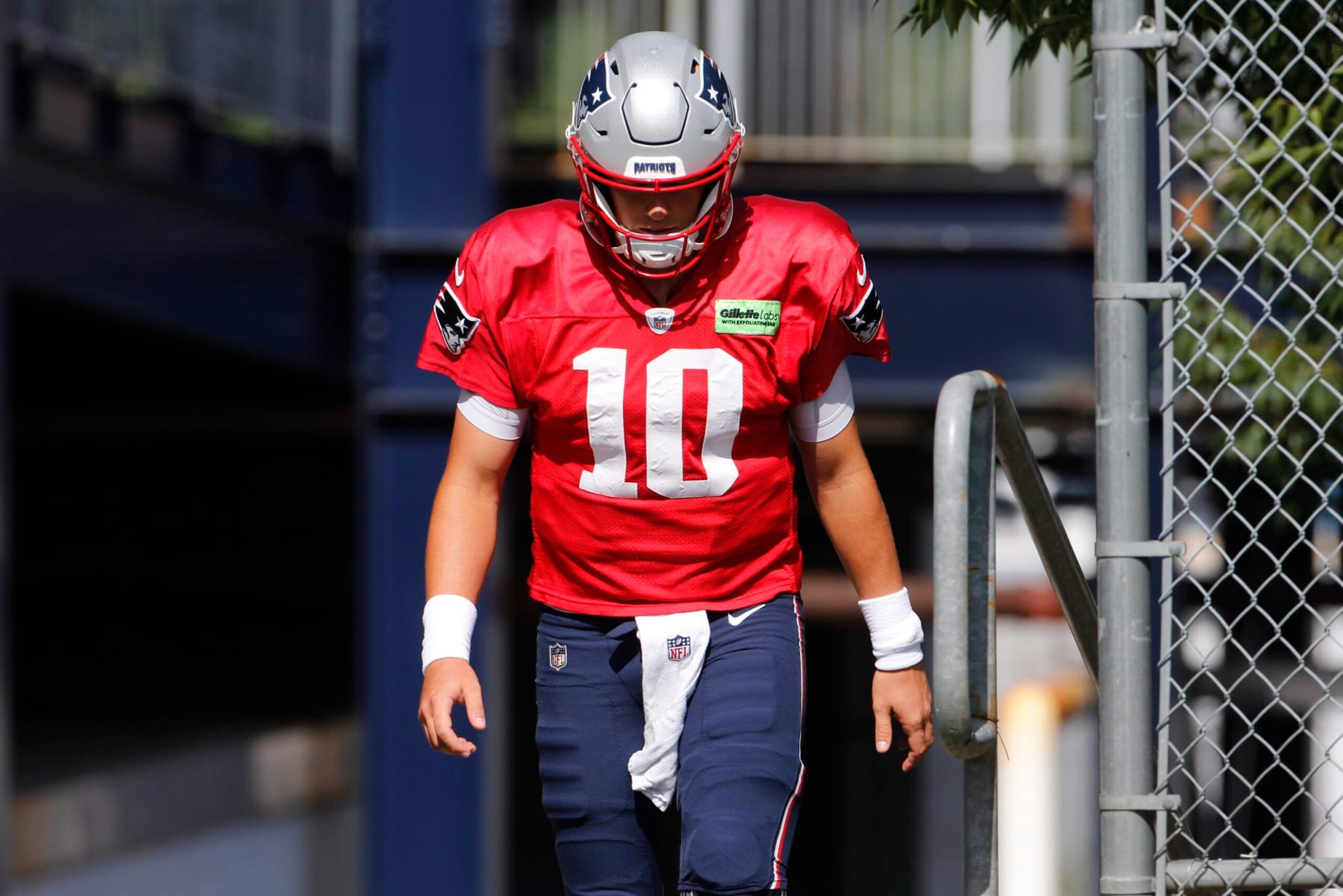 Foxborough, MA - August 8: Patriots quarterback Mac Jones walks off the practice field at the Patriots Training Camp at Gillette Stadium. (Photo by Carlin Stiehl for The Boston Globe via Getty Images)