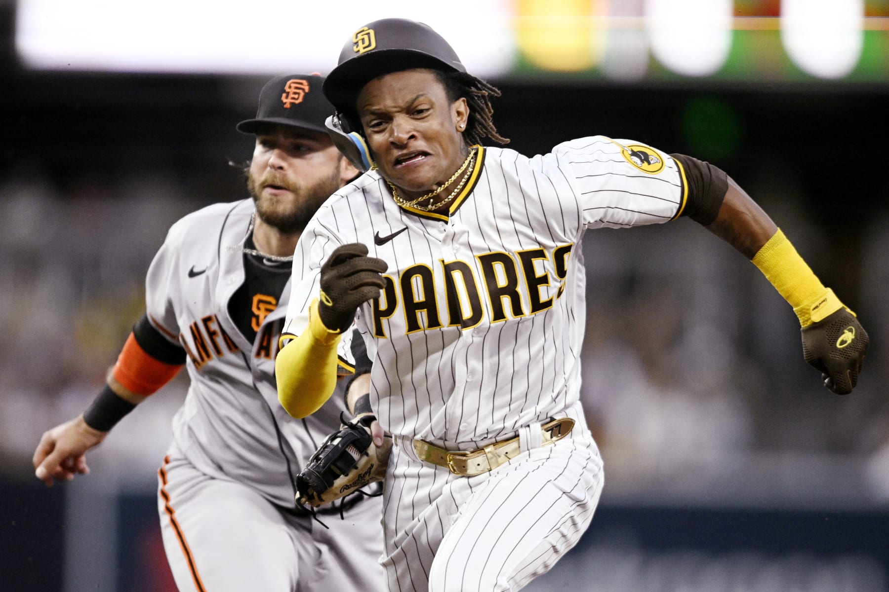 SAN DIEGO, CA - JULY 7:   C.J. Abrams #77 of the San Diego Padres is tagged out by Brandon Crawford #35 of the San Francisco Giants as hes caught in a run down during the third inning of a baseball game July 7, 2022 at Petco Park in San Diego, California. (Photo by Denis Poroy/Getty Images)