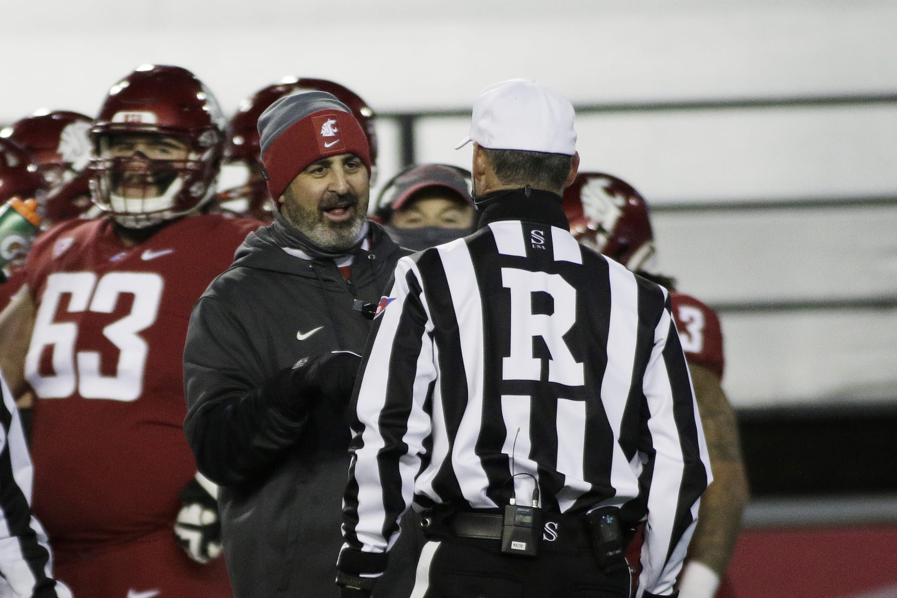 Washington State head coach Nick Rolovich, left, speaks with an official during the first half of an NCAA college football game against Oregon in Pullman, Wash., Saturday, Nov. 14, 2020. (AP Photo/Young Kwak) Washington State head coach Nick Rolovich, left, speaks with an official during the first half of an NCAA college football game against Oregon in Pullman, Wash., Saturday, Nov. 14, 2020. (AP Photo/Young Kwak)