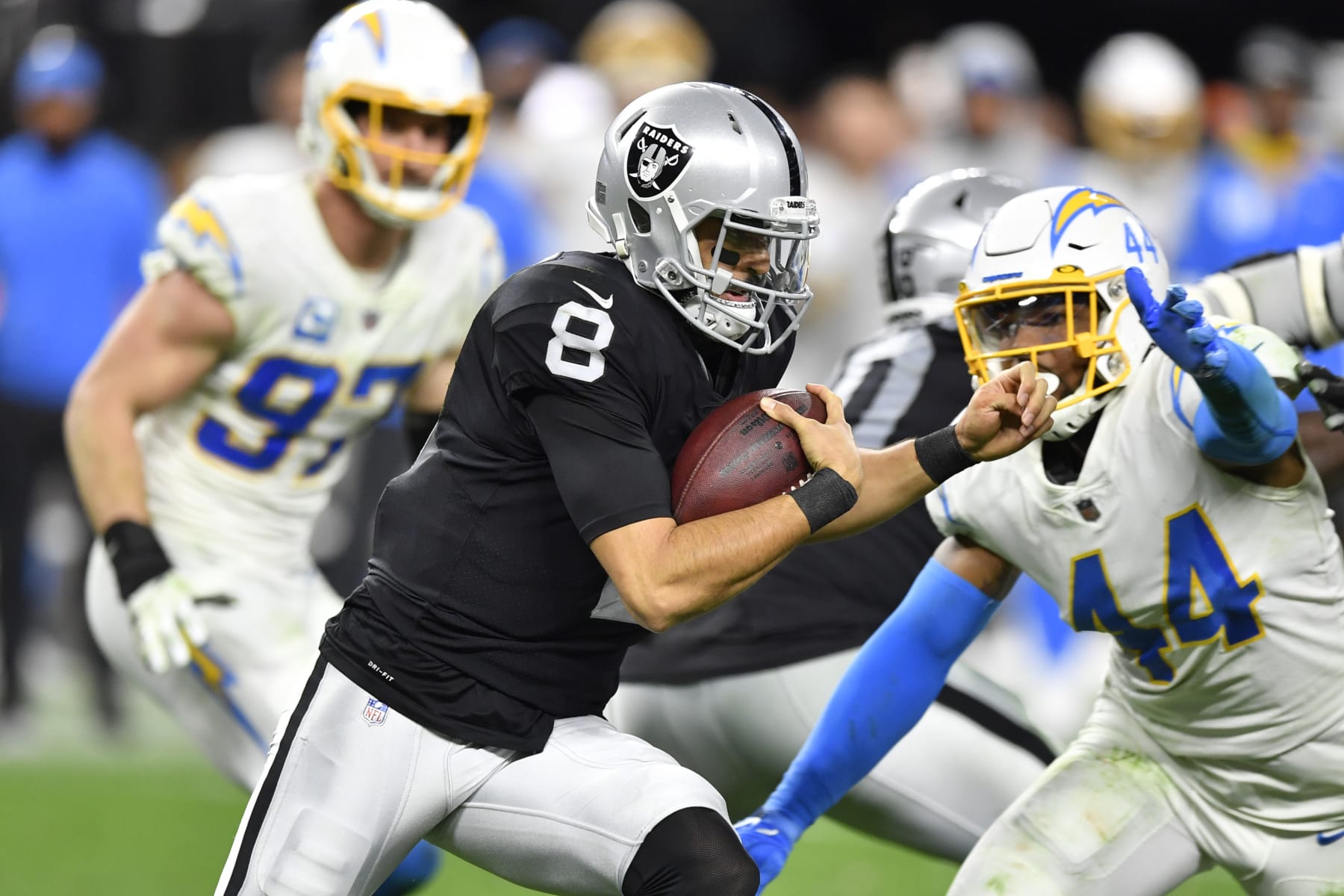 LAS VEGAS, NEVADA - JANUARY 09:  Quarterback Marcus Mariota #8 of the Las Vegas Raiders runs against the Los Angeles Chargers during the second half of a game at Allegiant Stadium on January 09, 2022 in Las Vegas, Nevada. The Raiders defeated the Chargers 35-32 in overtime. (Photo by Chris Unger/Getty Images)