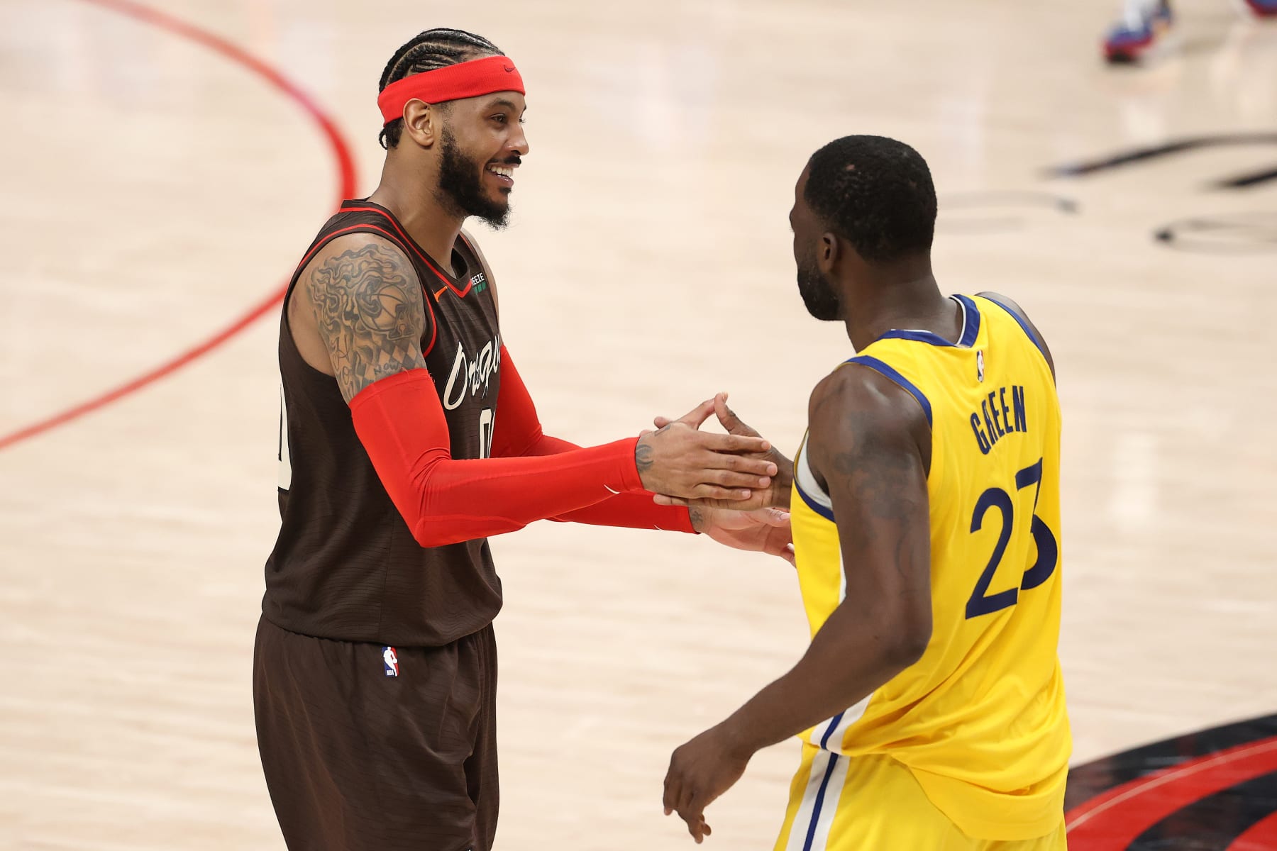 PORTLAND, OREGON - MARCH 03: Carmelo Anthony #00 of the Portland Trail Blazers and Draymond Green #23 of the Golden State Warriors hug after the Portland Trail Blazers defeated the Golden State Warriors 108-106 at Moda Center on March 03, 2021 in Portland, Oregon. NOTE TO USER: User expressly acknowledges and agrees that, by downloading and or using this photograph, User is consenting to the terms and conditions of the Getty Images License Agreement. (Photo by Abbie Parr/Getty Images)