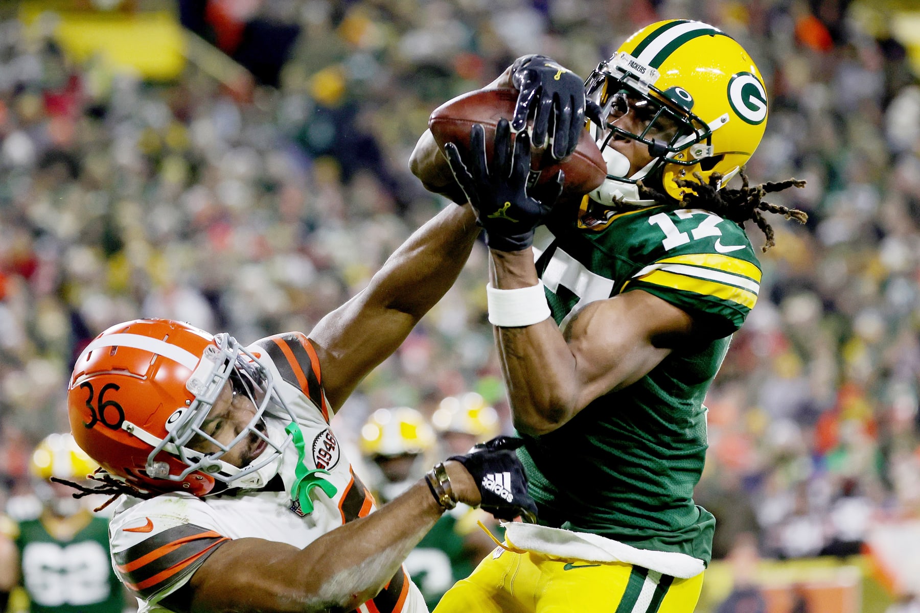 GREEN BAY, WISCONSIN - DECEMBER 25: Davante Adams #17 of the Green Bay Packers makes a catch for a touchdown while being guarded by M.J. Stewart Jr. #36 of the Cleveland Browns in the second quarter at Lambeau Field on December 25, 2021 in Green Bay, Wisconsin. (Photo by Stacy Revere/Getty Images)
