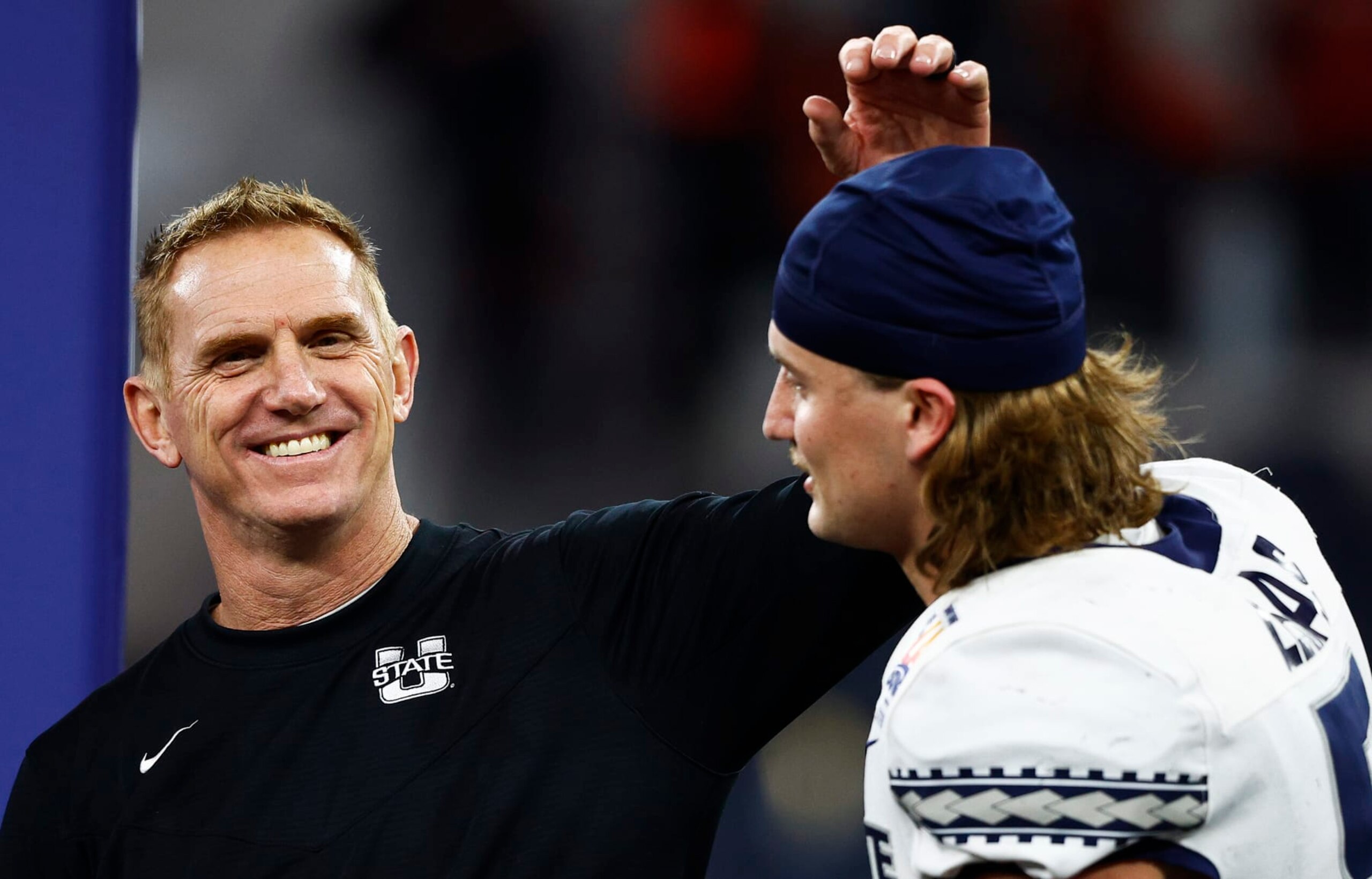 INGLEWOOD, CALIFORNIA - DECEMBER 18: Head Coach Blake Anderson of the Utah State Aggies congratulates teammate Cooper Legas #5 after the game against the Oregon State Beavers of the Jimmy Kimmel LA BOWL Presented by Stifel at SoFi Stadium on December 18, 2021 in Inglewood, California. (Photo by Ronald Martinez/Getty Images)
