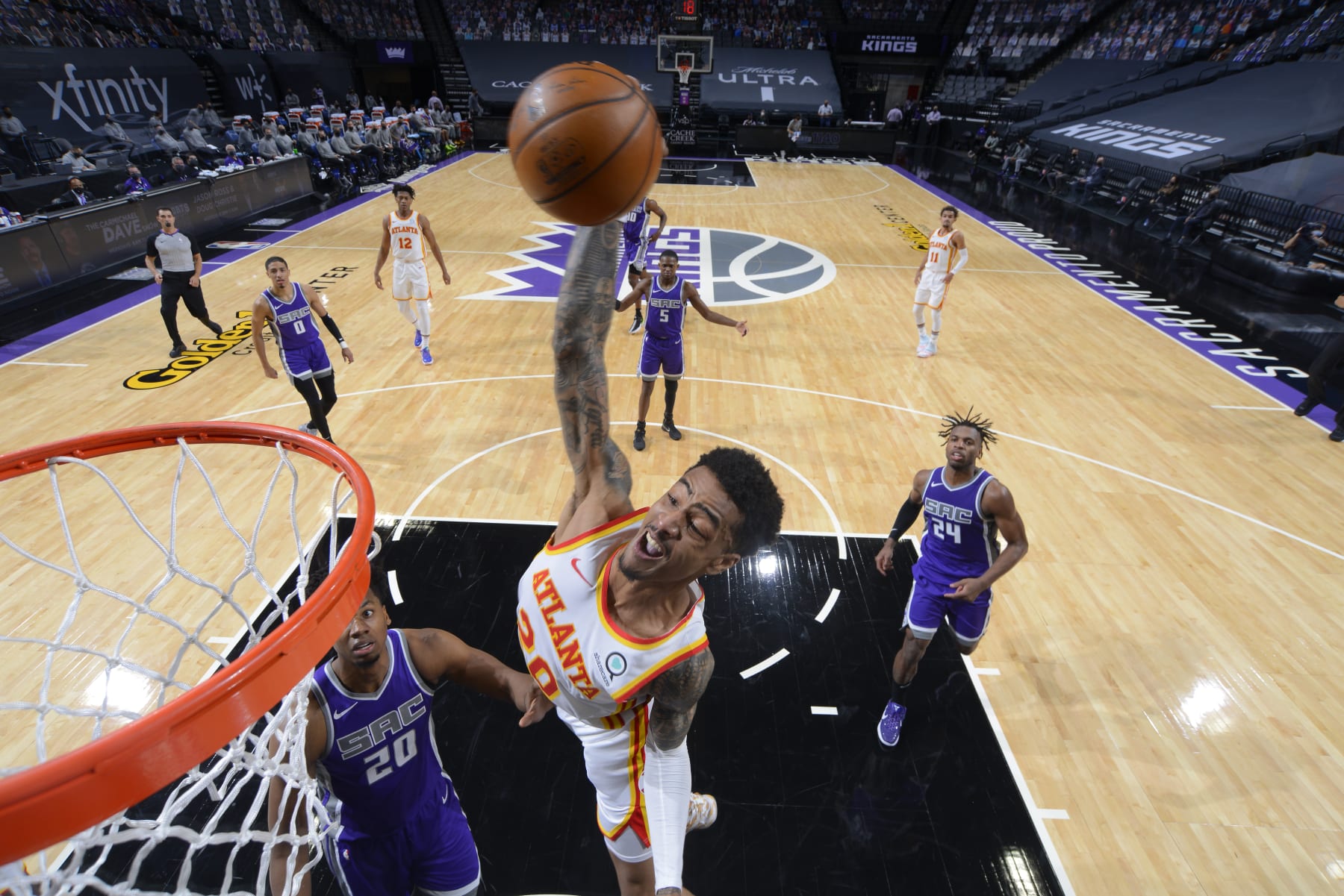 SACRAMENTO, CA - MARCH 24: John Collins #20 of the Atlanta Hawks dunks the ball against the Sacramento Kings on March 24, 2021 at Golden 1 Center in Sacramento, California. NOTE TO USER: User expressly acknowledges and agrees that, by downloading and or using this Photograph, user is consenting to the terms and conditions of the Getty Images License Agreement. Mandatory Copyright Notice: Copyright 2021 NBAE (Photo by Rocky Widner/NBAE via Getty Images)