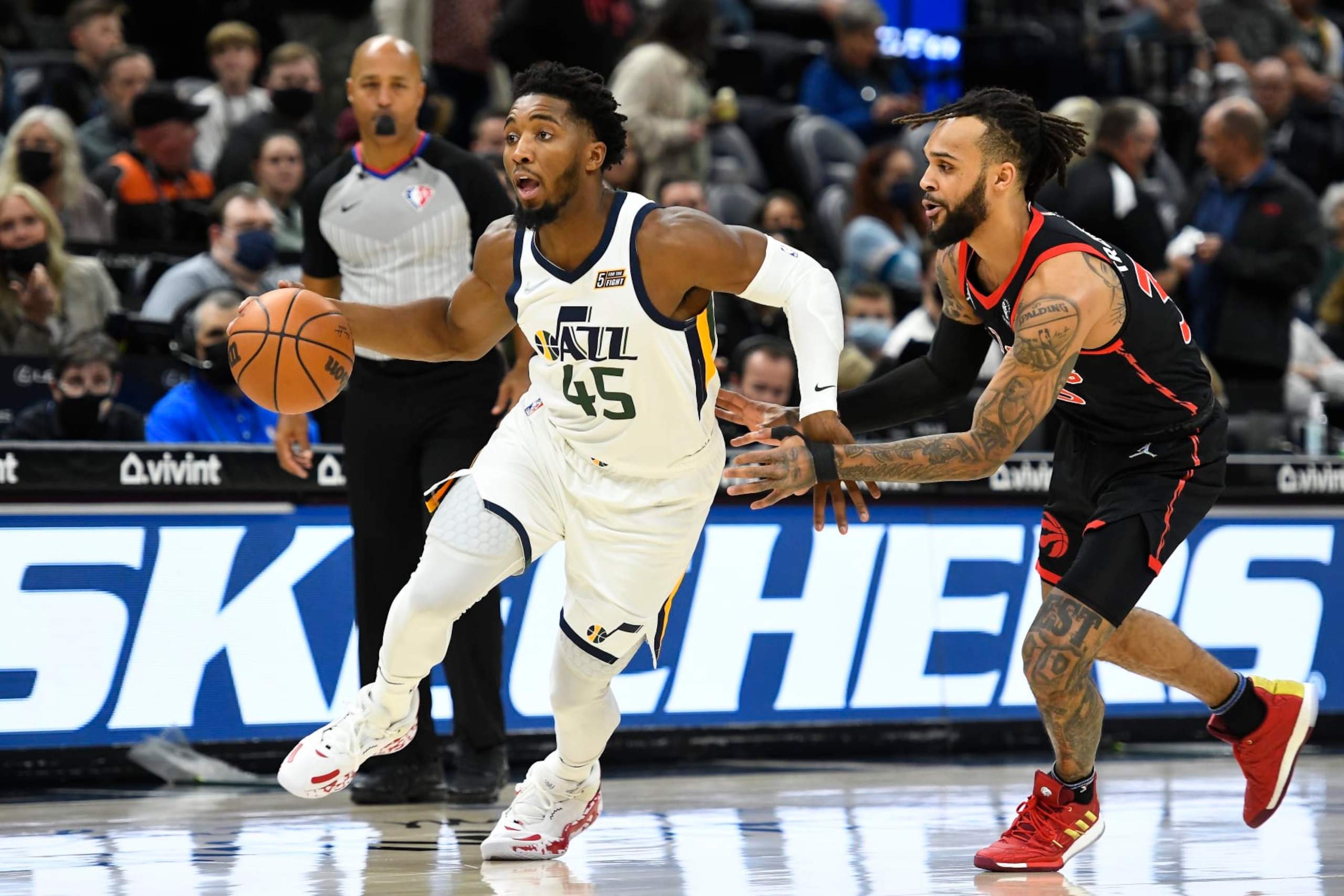 SALT LAKE CITY, UTAH - NOVEMBER 18: Donovan Mitchell #45 of the Utah Jazz drives past Gary Trent Jr. #33 of the Toronto Raptors in the first half during a game at Vivint Smart Home Arena on November 18, 2021 in Salt Lake City, Utah. NOTE TO USER: User expressly acknowledges and agrees that, by downloading and or using this photograph, User is consenting to the terms and conditions of the Getty Images License Agreement. (Photo by Alex Goodlett/Getty Images)