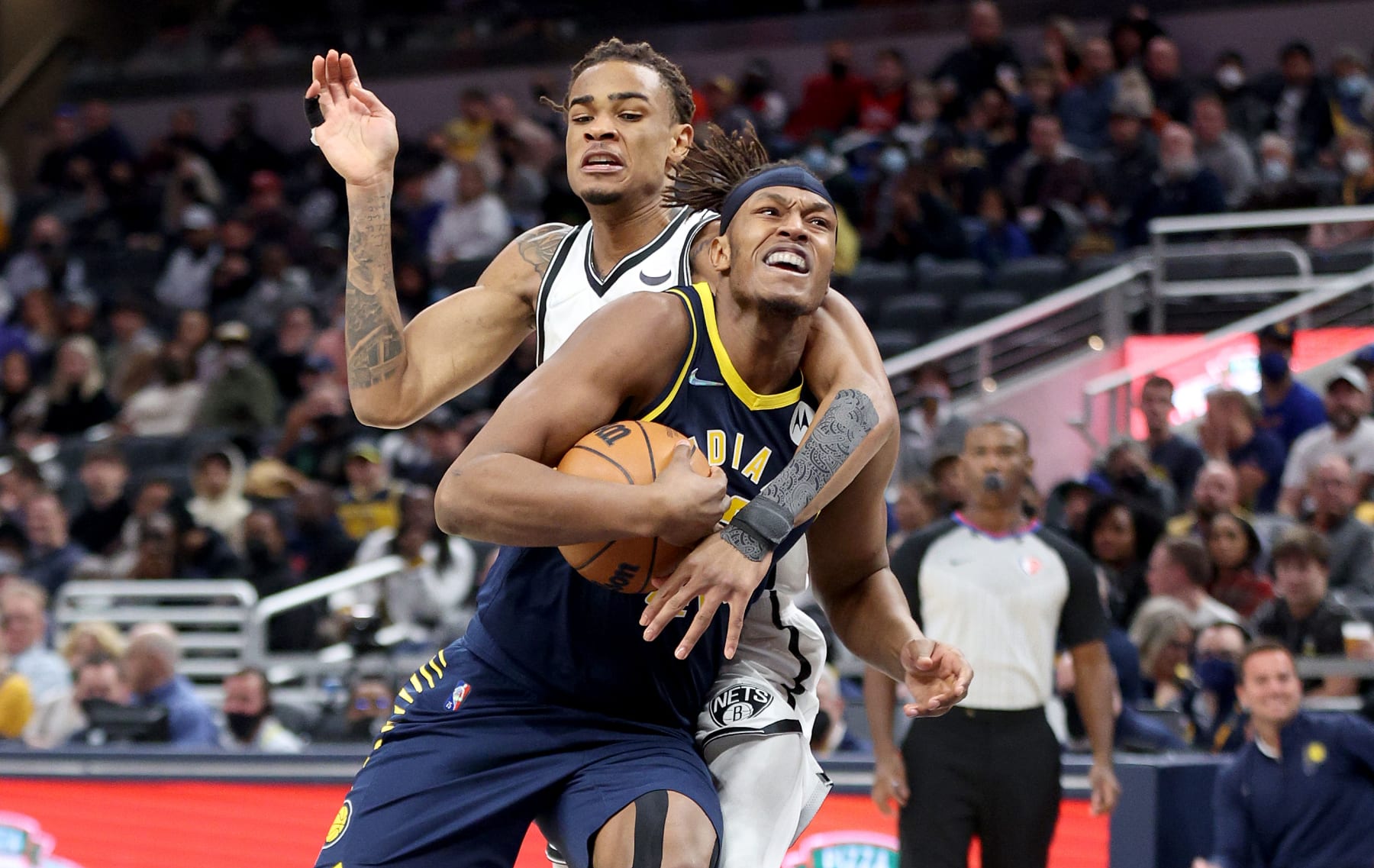 INDIANAPOLIS, INDIANA - JANUARY 05:   Myles Turner #33 of the Indiana Pacers is fouled by Nicolas Claxton #33 of the Brooklyn Nets at Gainbridge Fieldhouse on January 05, 2022 in Indianapolis, Indiana.    NOTE TO USER: User expressly acknowledges and agrees that, by downloading and or using this Photograph, user is consenting to the terms and conditions of the Getty Images License Agreement.  (Photo by Andy Lyons/Getty Images)