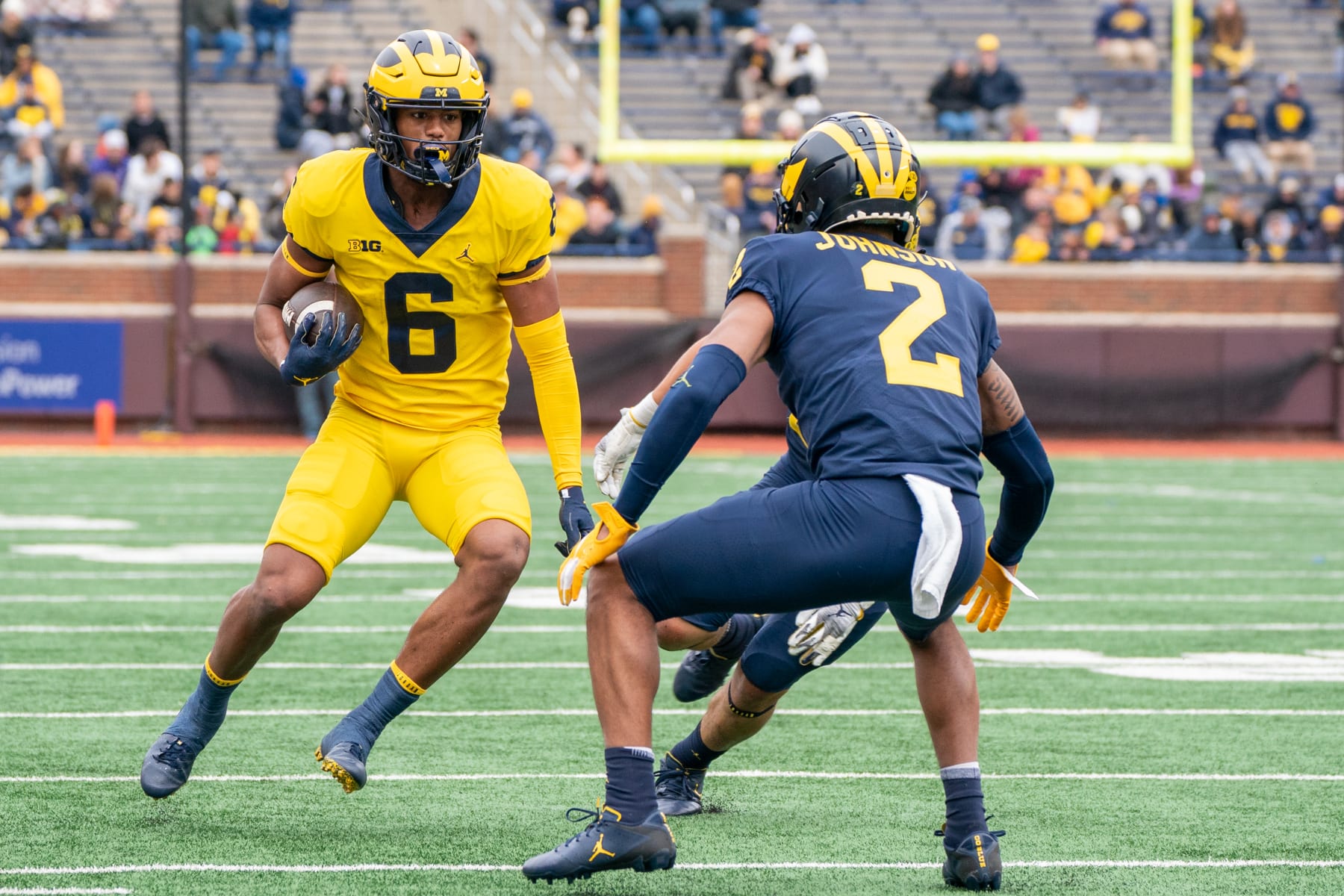 ANN ARBOR, MI - APRIL 02: Cornelius Johnson #6 of the Maize Team runs the ball against Will Johnson #2 of the Blue Team during the spring football game at Michigan Stadium on April 2, 2022 in Ann Arbor, Michigan.  (Photo by Jaime Crawford/Getty Images)