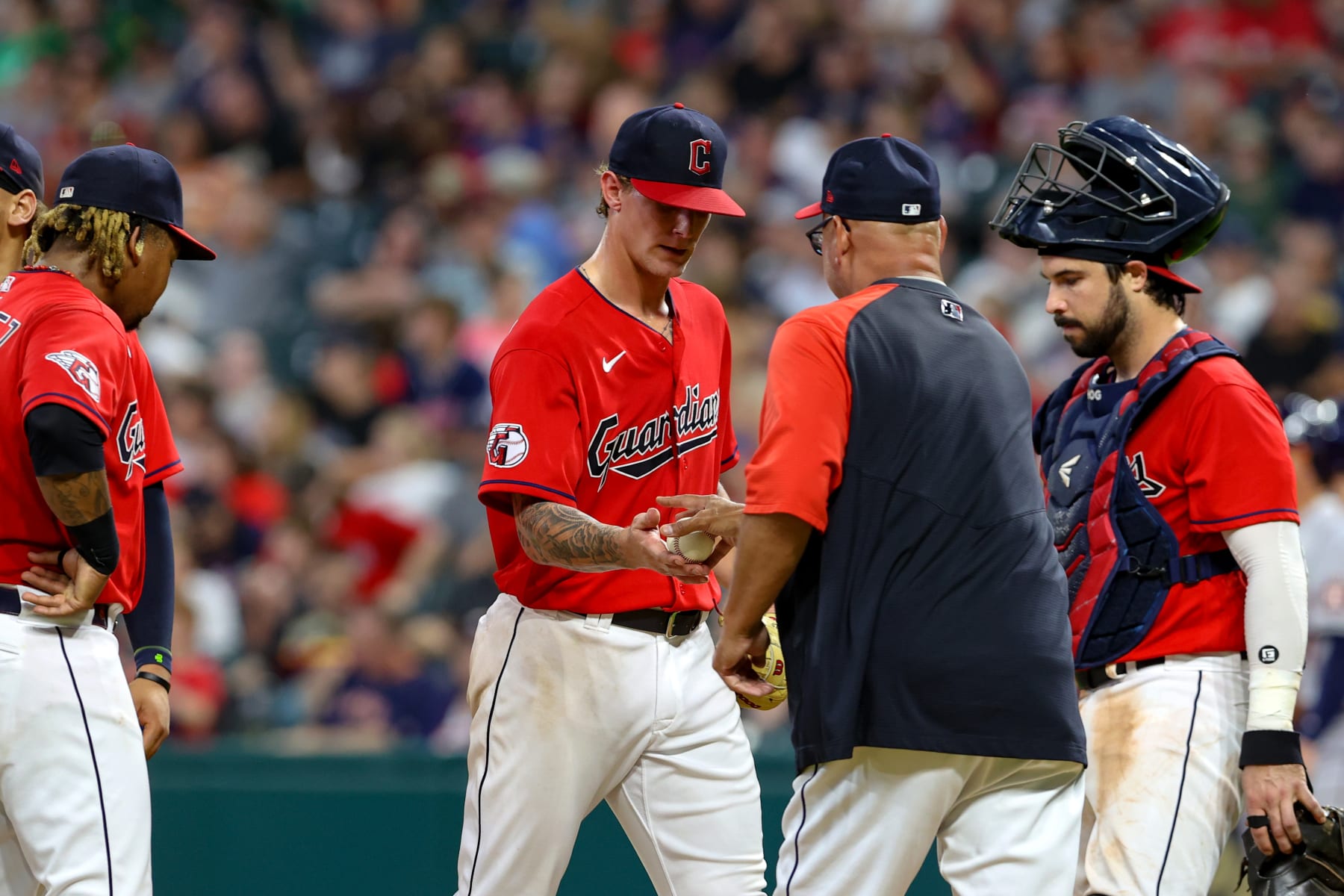 CLEVELAND, OH - AUGUST 04: Cleveland Guardians starting pitcher Zach Plesac (34) hands the baseball to Cleveland Guardians manager Terry Francona (77) as he leaves the game during the fifth inning of the the Major League Baseball game between the Houston Astros and Cleveland Guardians on August 4, 2022, at Progressive Field in Cleveland, OH. (Photo by Frank Jansky/Icon Sportswire via Getty Images)