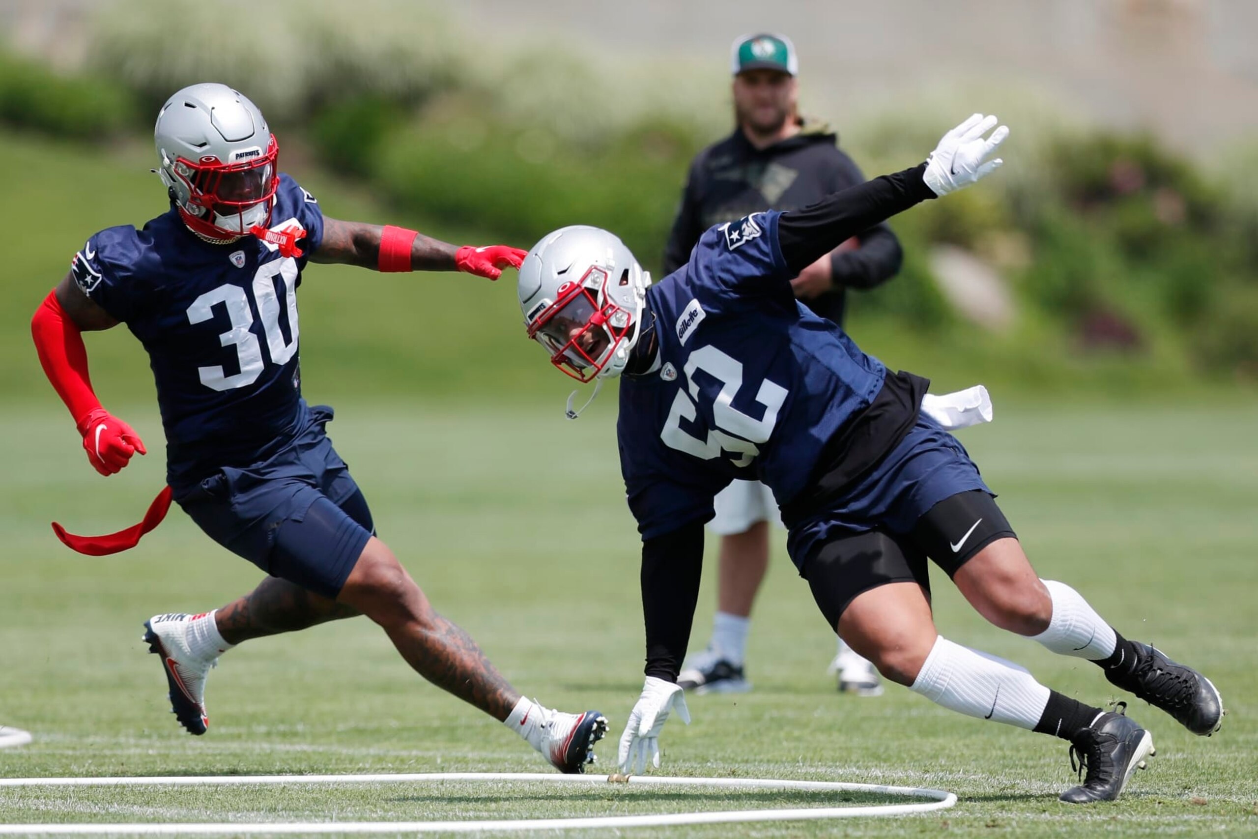 New England Patriots defensive back Marcus Jones (52) and linebacker Mack Wilson Sr. (30) take part in drills at the NFL football team's practice facility in Foxborough, Mass., Tuesday, May 31, 2022 (AP Photo/Michael Dwyer)