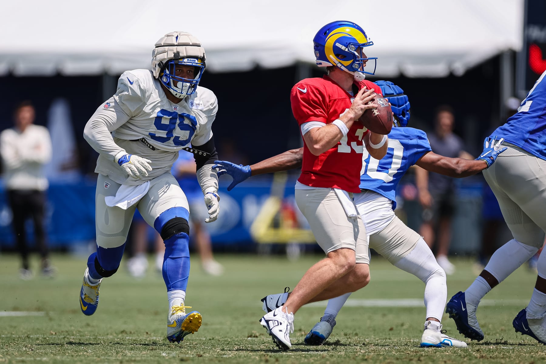 IRVINE, CA - JULY 29: Aaron Donald #99 of the Los Angeles Rams closes in on John Wolford #13 during training camp at University of California Irvine on July 29, 2022 in Irvine, California. (Photo by Scott Taetsch/Getty Images)
