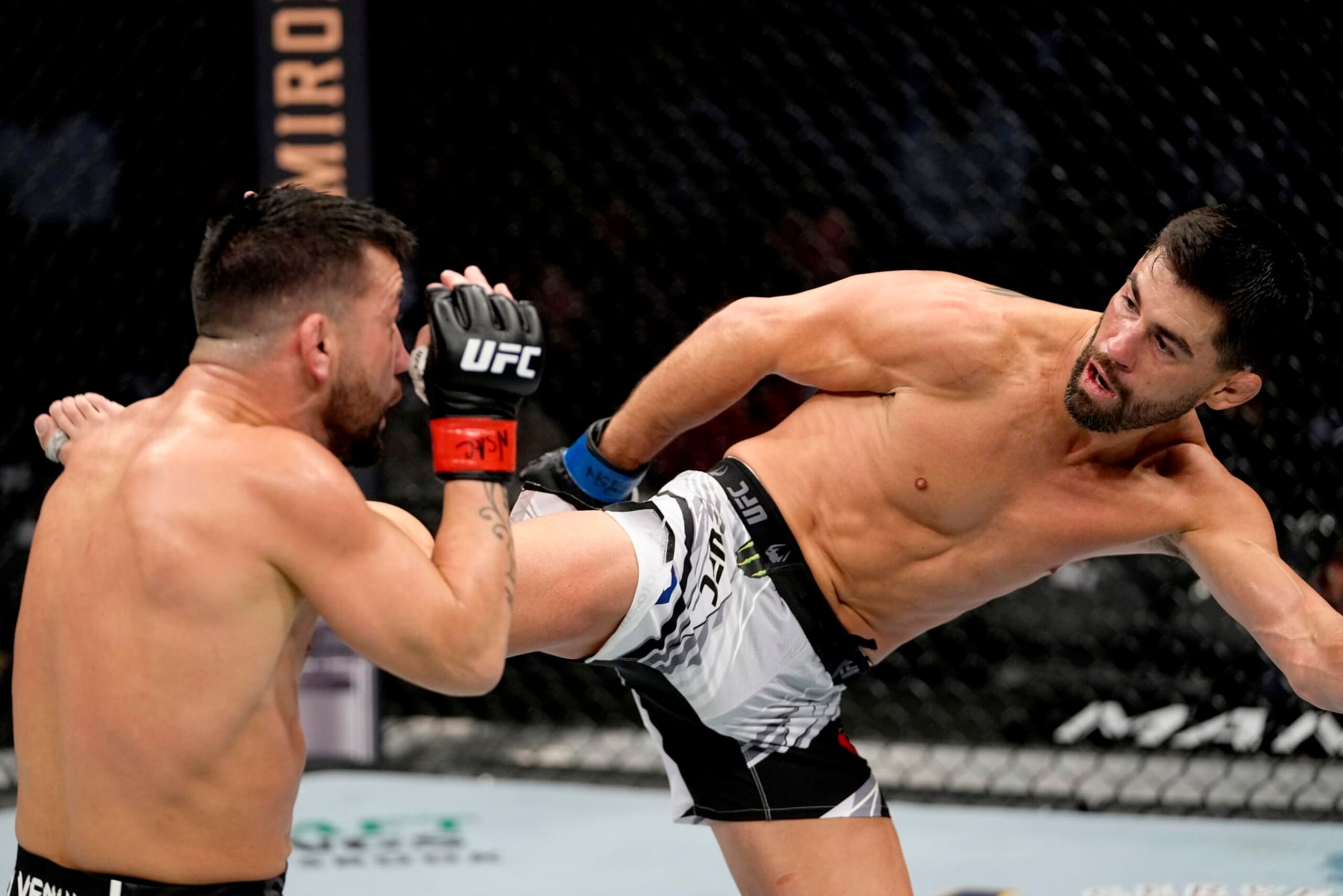 LAS VEGAS, NEVADA - DECEMBER 11: Dominick Cruz kicks Pedro Munhoz of Brazil in their bantamweight bout during the UFC 269 on December 11, 2021 in Las Vegas, Nevada. (Photo by Jeff Bottari/Zuffa LLC)