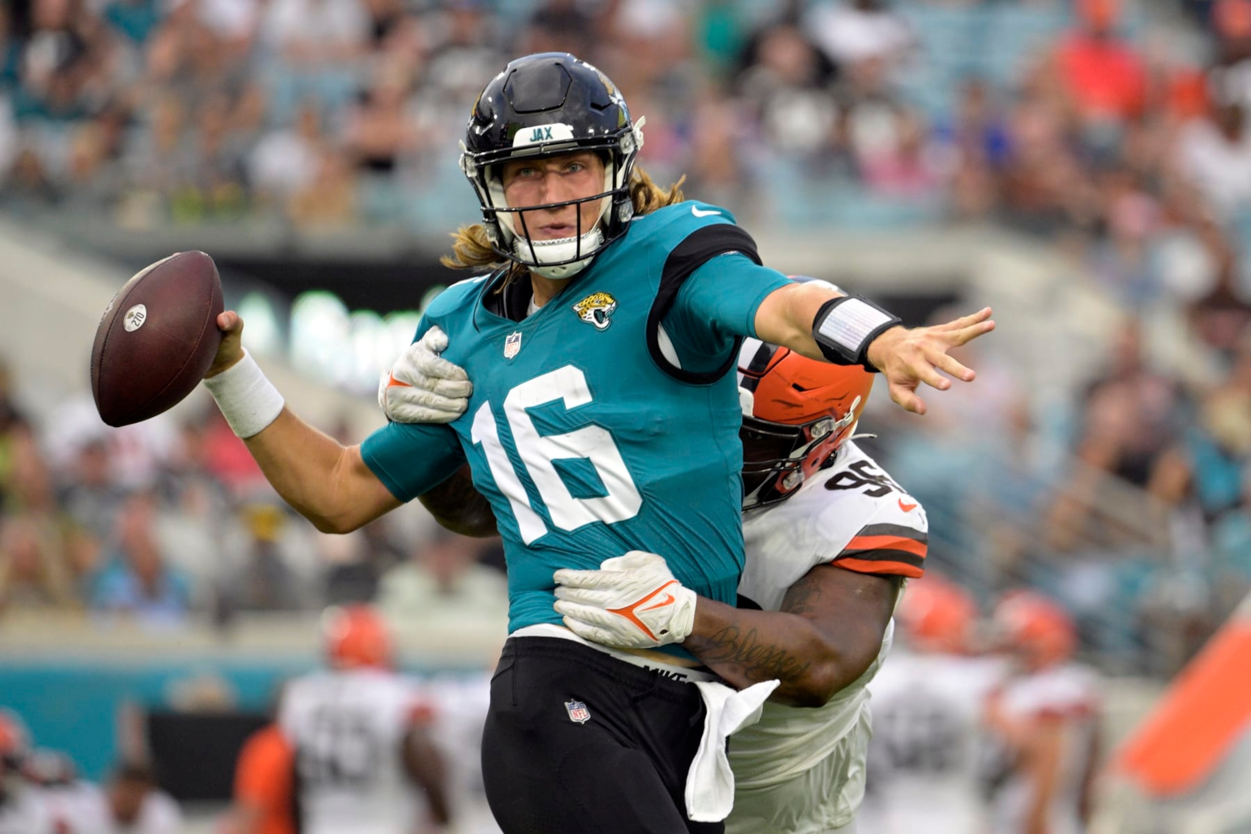 Jacksonville Jaguars quarterback Trevor Lawrence (16) throws a pass has he is hit by Cleveland Browns defensive tackle Jordan Elliott (96) during the first half of an NFL preseason football game, Friday, Aug. 12, 2022, in Jacksonville, Fla. (AP Photo/Phelan M. Ebenhack) Jacksonville Jaguars quarterback Trevor Lawrence (16) throws a pass has he is hit by Cleveland Browns defensive tackle Jordan Elliott (96) during the first half of an NFL preseason football game, Friday, Aug. 12, 2022, in Jacksonville, Fla. (AP Photo/Phelan M. Ebenhack)
