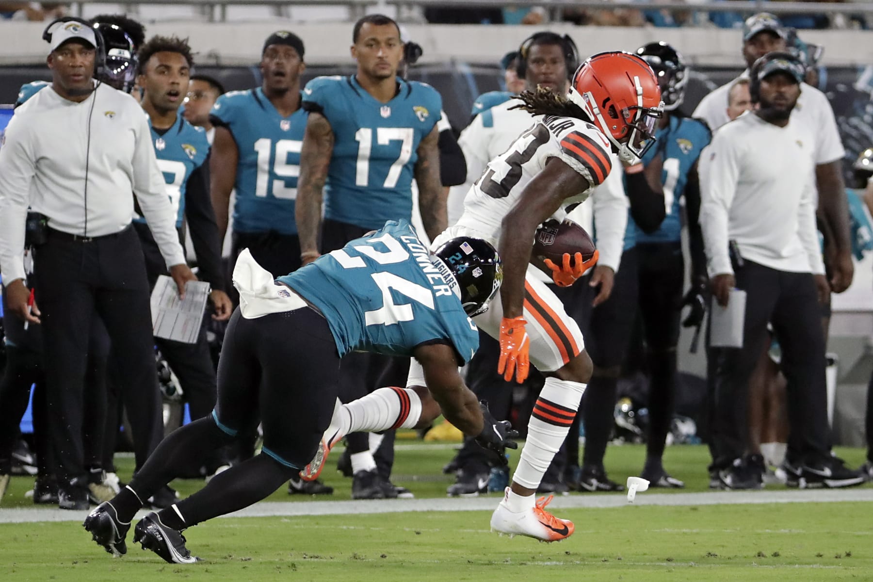 Cleveland Browns cornerback Martin Emerson Jr., right, runs past Jacksonville Jaguars running back Snoop Conner (24) after intercepting a pass during the second half of an NFL preseason football game, Friday, Aug. 12, 2022, in Jacksonville, Fla. (AP Photo/Stephen B. Morton)