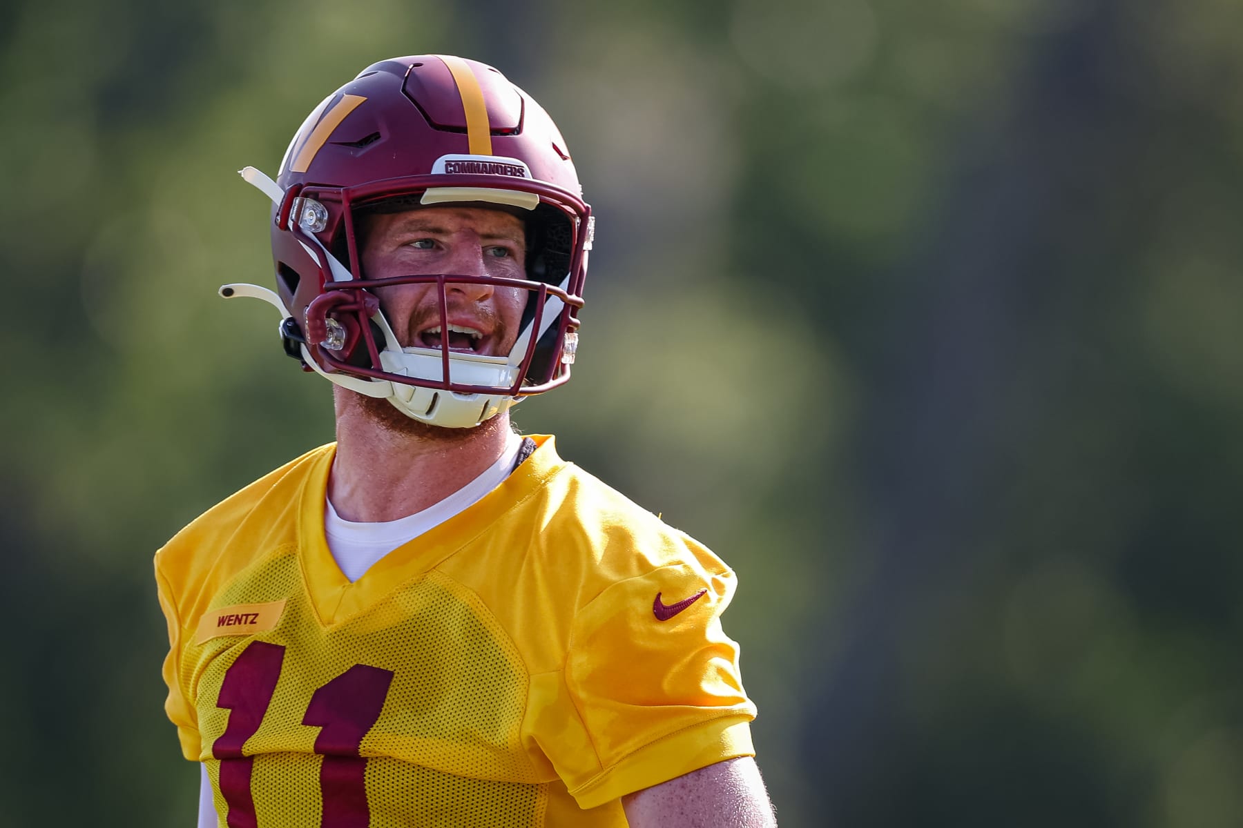 ASHBURN, VA - AUGUST 10: Carson Wentz #11 of the Washington Commanders reacts during training camp at INOVA Sports Performance Center on August 10, 2022 in Ashburn, Virginia. (Photo by Scott Taetsch/Getty Images)