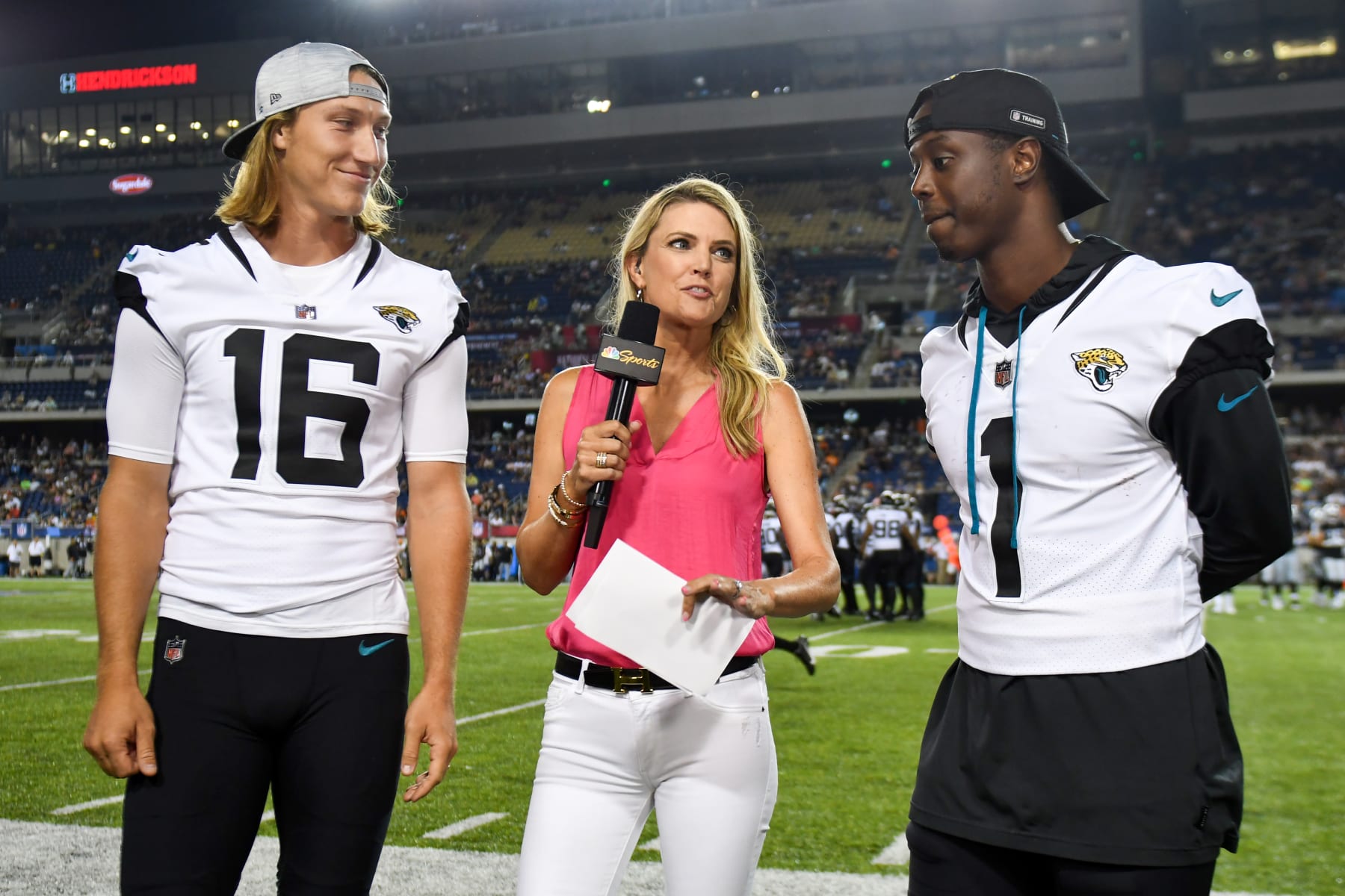 CANTON, OHIO - AUGUST 04: NBC Sports field reporter Melissa Stark interviews Trevor Lawrence #16 and Travis Etienne Jr. #1 of the Jacksonville Jaguars during the second half of the 2022 Pro Hall of Fame Game against the Las Vegas Raiders at Tom Benson Hall of Fame Stadium on August 04, 2022 in Canton, Ohio. (Photo by Nick Cammett/Getty Images)