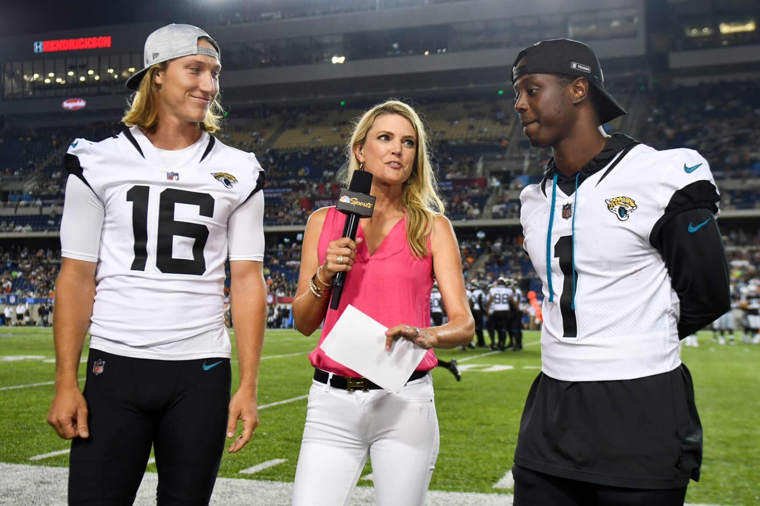 CANTON, OHIO - AUGUST 04: NBC Sports field reporter Melissa Stark interviews Trevor Lawrence #16 and Travis Etienne Jr. #1 of the Jacksonville Jaguars during the second half of the 2022 Pro Hall of Fame Game against the Las Vegas Raiders at Tom Benson Hall of Fame Stadium on August 04, 2022 in Canton, Ohio. (Photo by Nick Cammett/Getty Images)