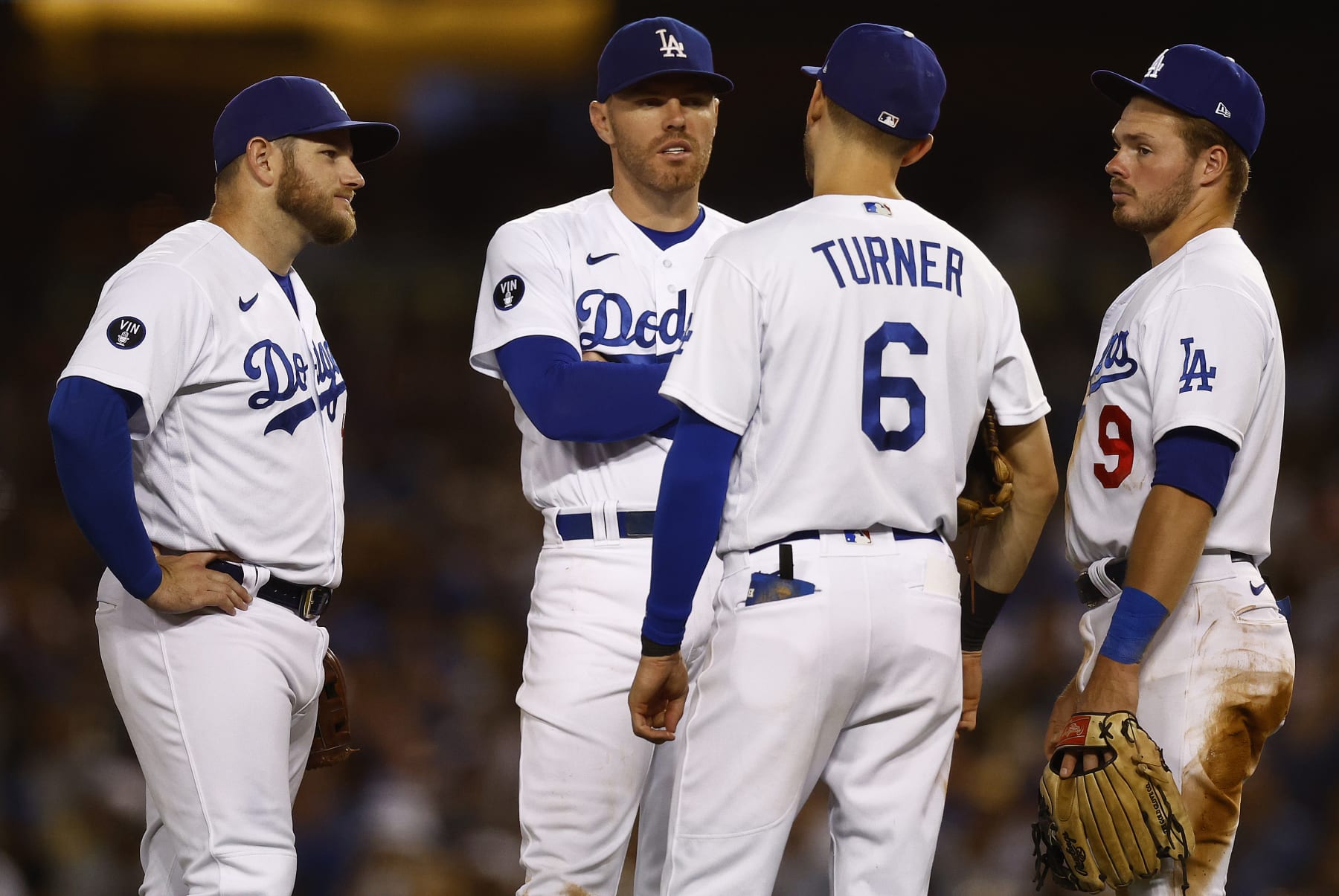 LOS ANGELES, CALIFORNIA - AUGUST 10:   Max Muncy #13, Freddie Freeman #5, Trea Turner #6 and Gavin Lux #9 of the Los Angeles Dodgers in the fifth inning at Dodger Stadium on August 10, 2022 in Los Angeles, California. (Photo by Ronald Martinez/Getty Images)