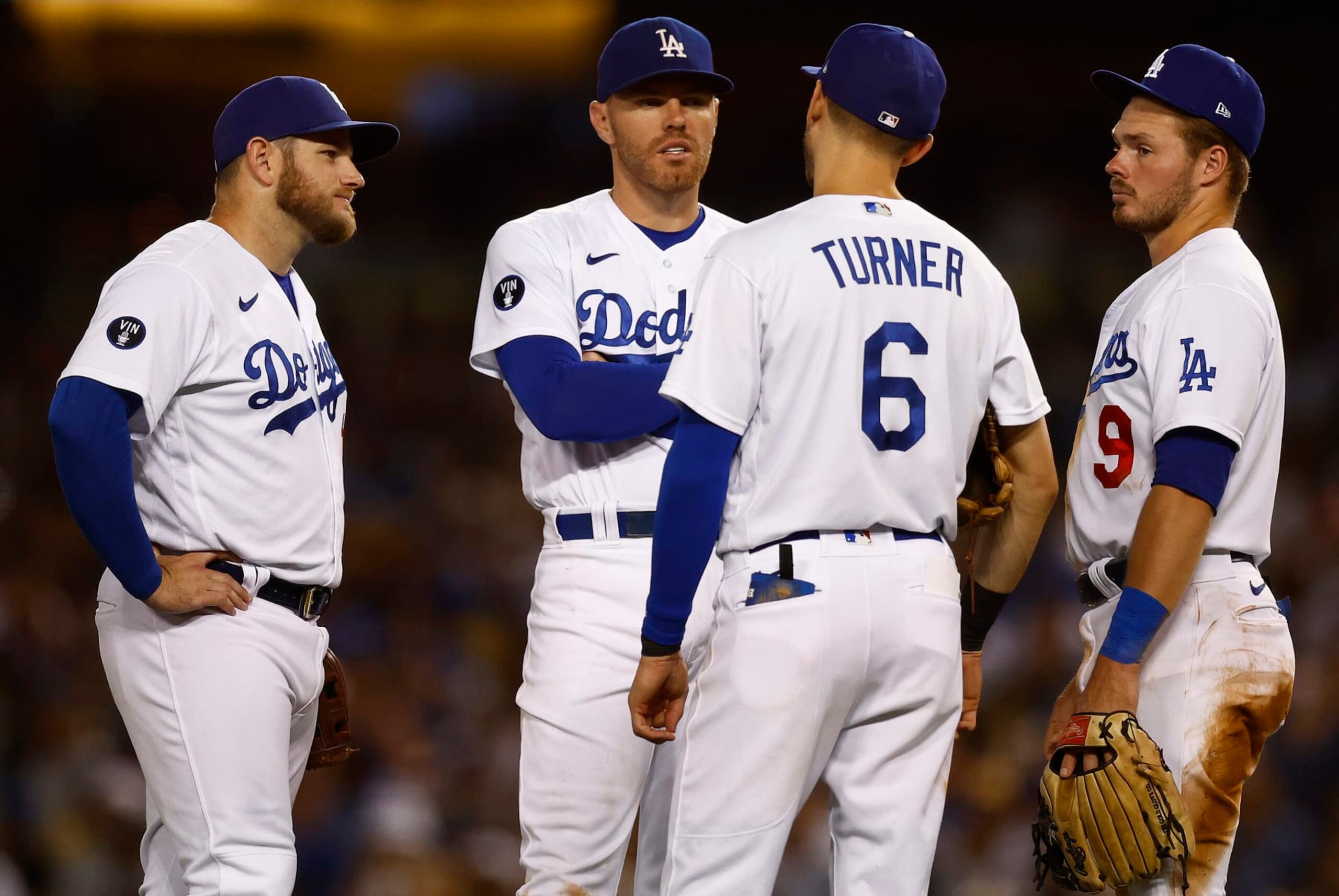 LOS ANGELES, CALIFORNIA - AUGUST 10:   Max Muncy #13, Freddie Freeman #5, Trea Turner #6 and Gavin Lux #9 of the Los Angeles Dodgers in the fifth inning at Dodger Stadium on August 10, 2022 in Los Angeles, California. (Photo by Ronald Martinez/Getty Images)